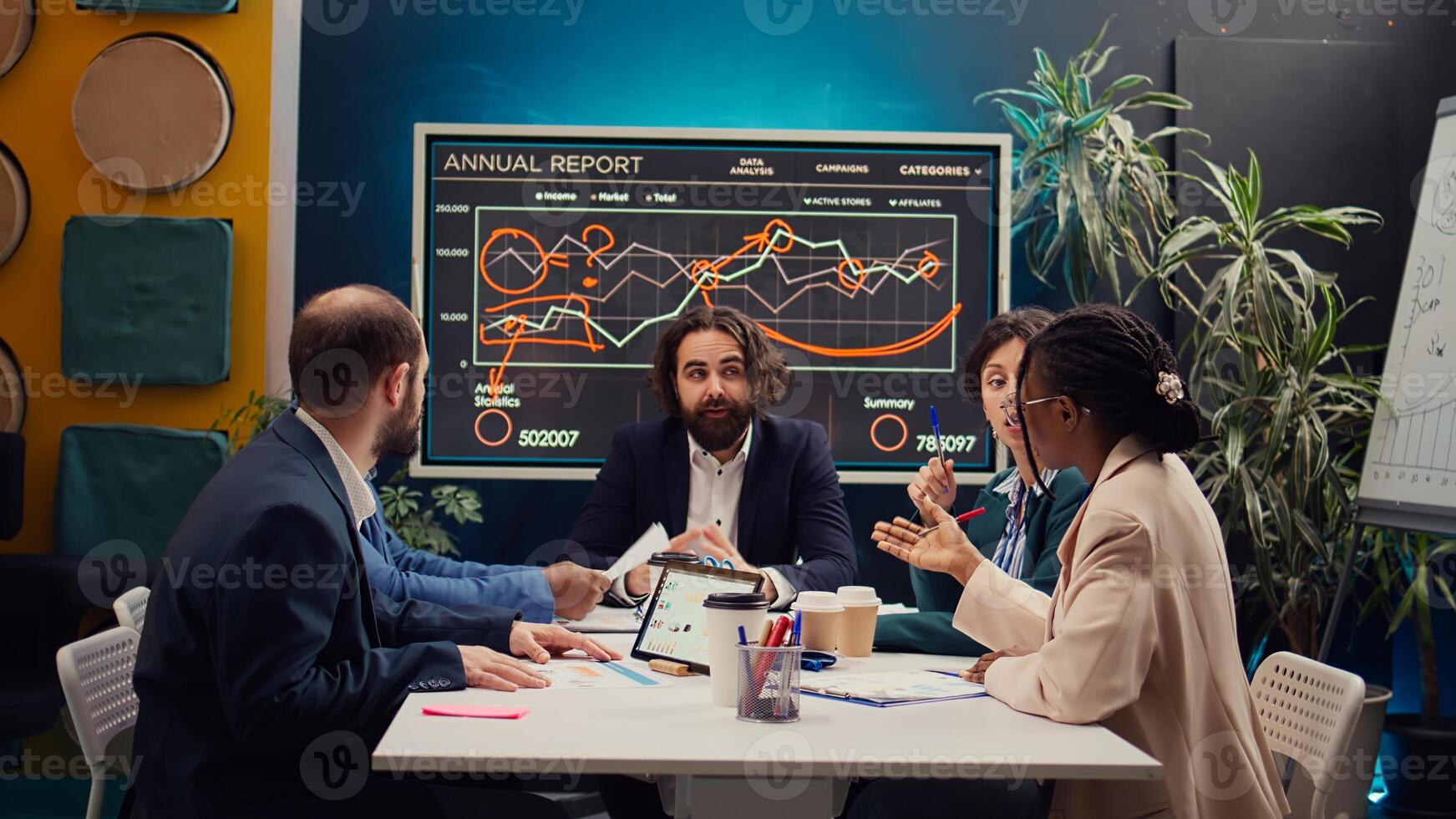 Startup team evaluating infographics data in an executive meeting, corporate restructuring or organizational changes. Adapting the organization to evolving market conditions. Camera B. photo