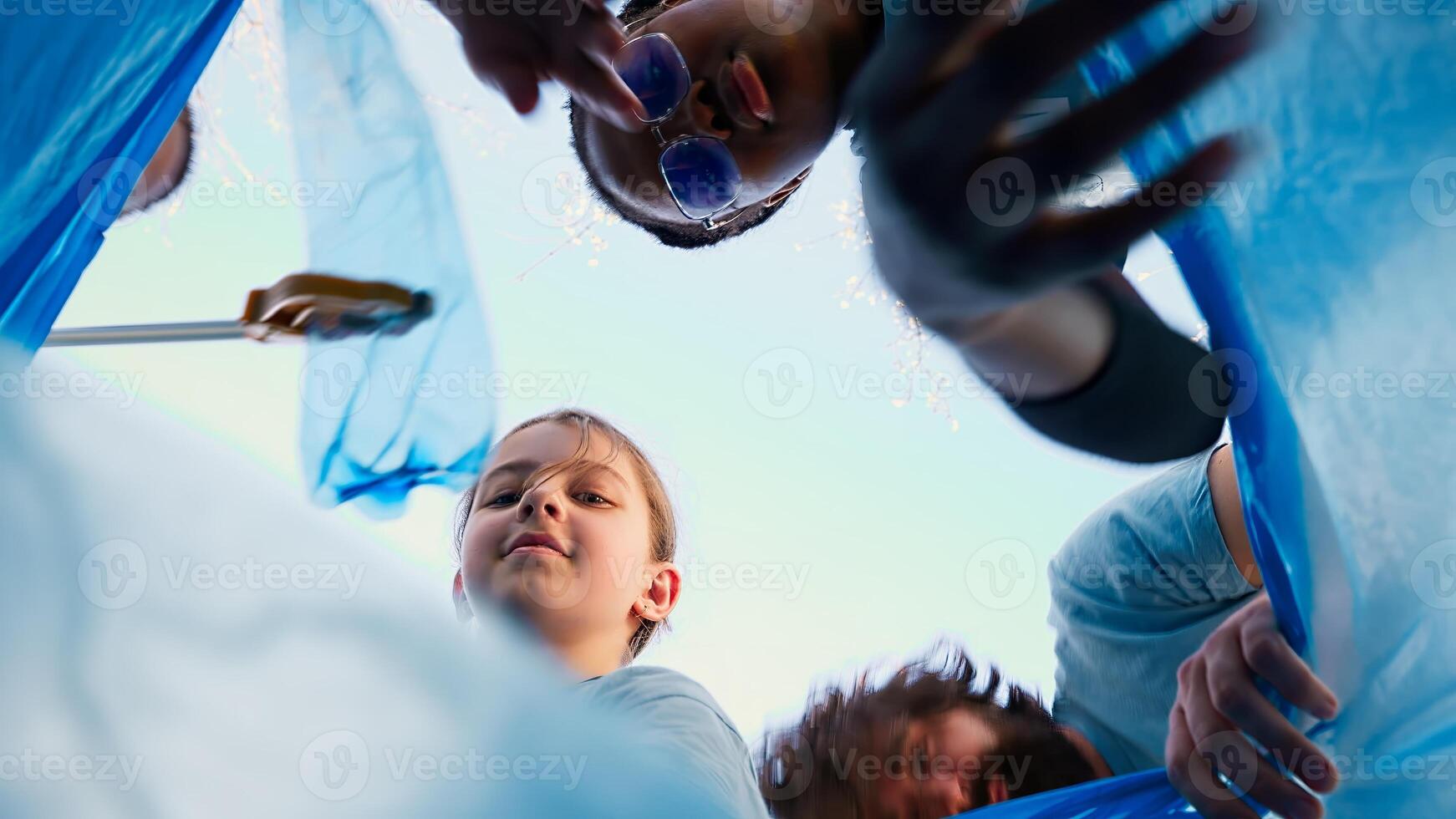 POV of environmental activists gathering trash and plastic litter in a garbage bag, recycling rubbish in a disposal and cleaning the forest. People support zero waste activism. Camera A. photo