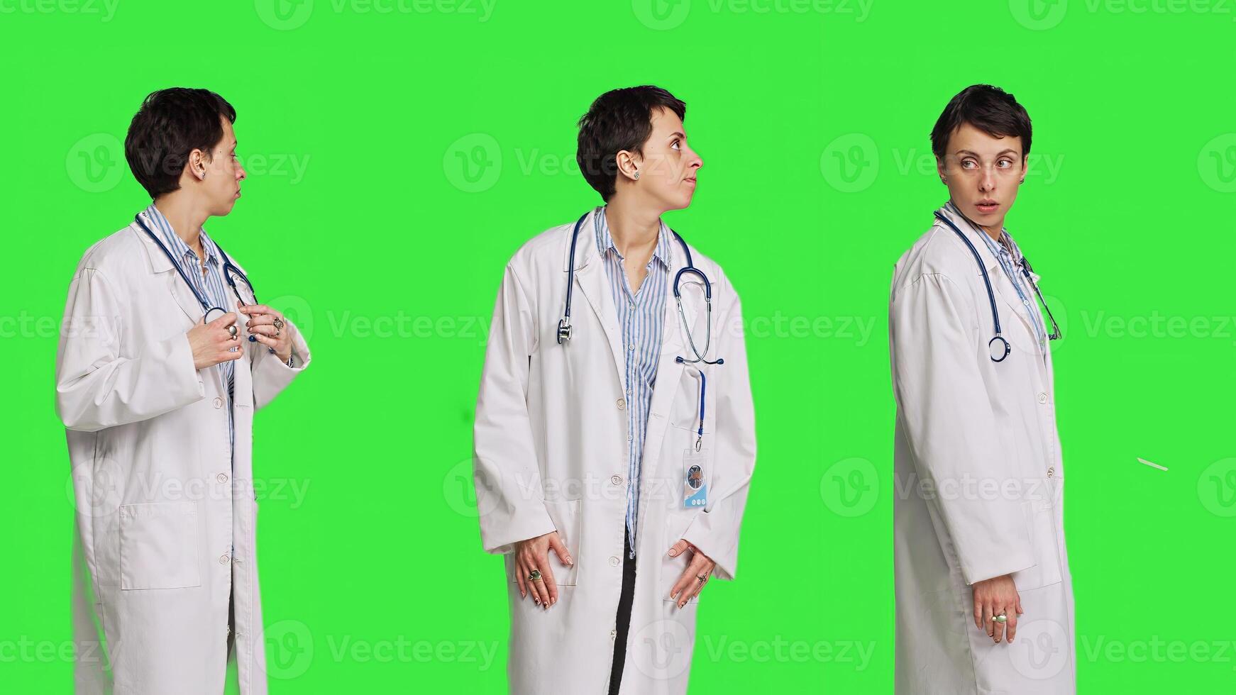 General practitioner waiting for patients to attend checkup appointments, feeling impatient against greenscreen backdrop. Woman physician with white coat waits for people, confident medic. Camera B. photo