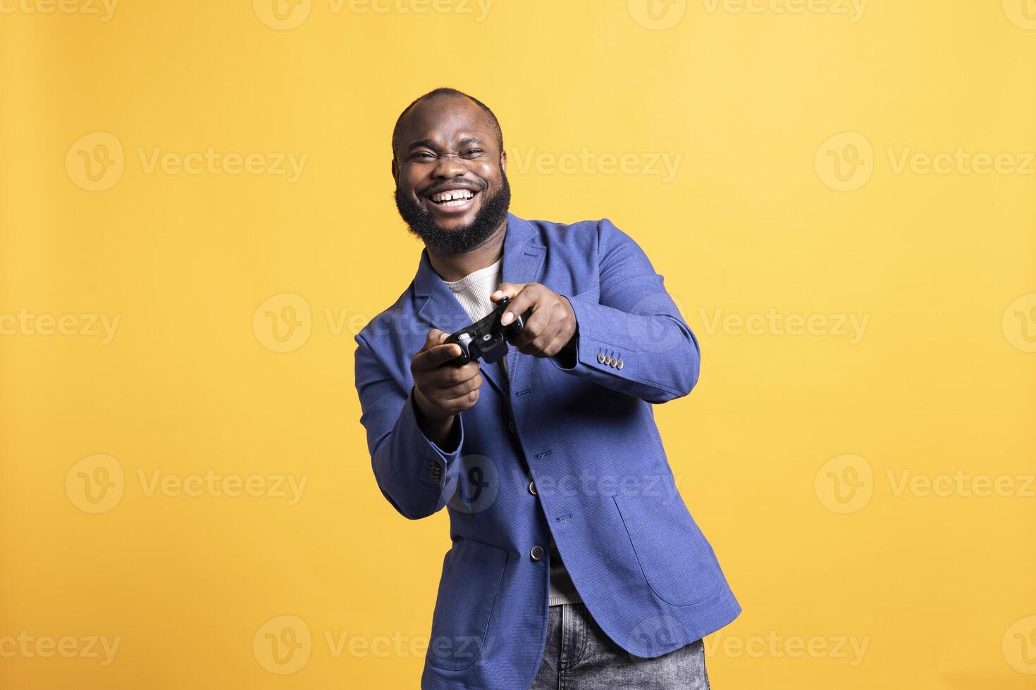 Portrait of jolly man man laughing while playing videogames with controller, having fun, studio background. African american gamer entertained by participating in online multiplayer game photo