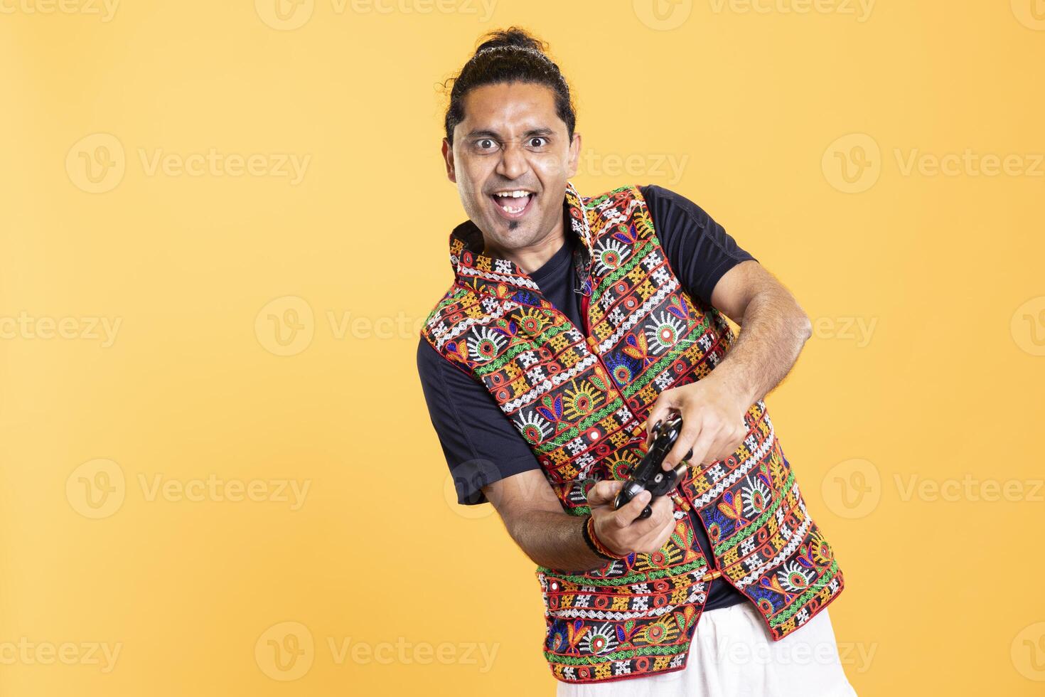 Portrait of euphoric gamer feeling rush while killing foes in videogame with motion controlled joystick. Ecstatic man pressing gamepad buttons, enjoying slaying enemies, studio backdrop photo