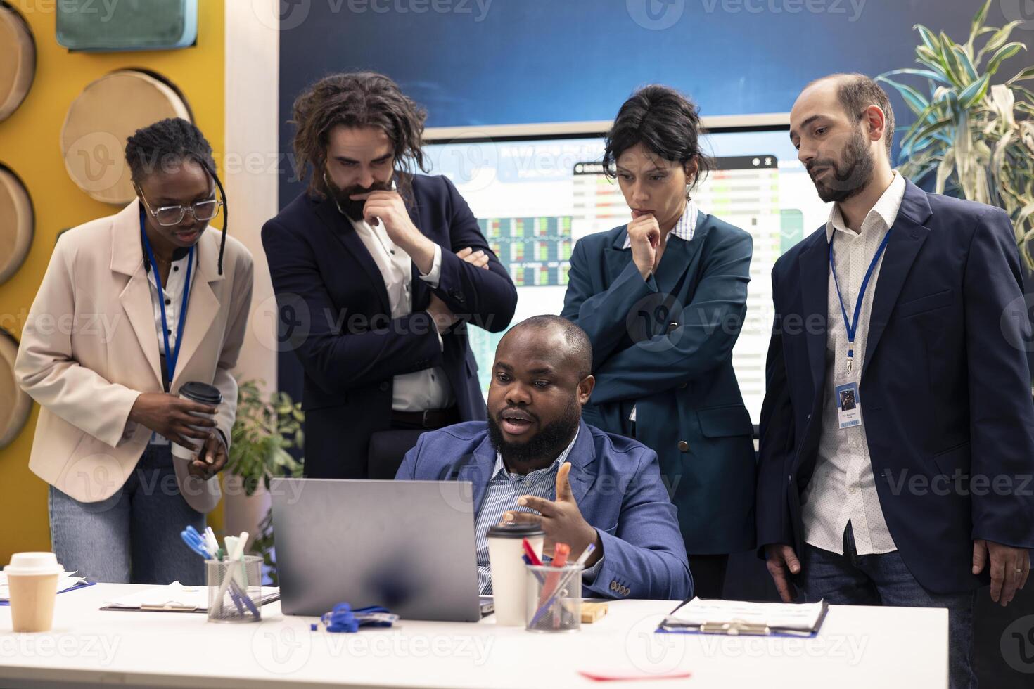 Diverse business colleagues reviewing project details to ensure objectives accomplishment, calculating infographics on laptop and finding ways to increase financial activity. Business management. photo