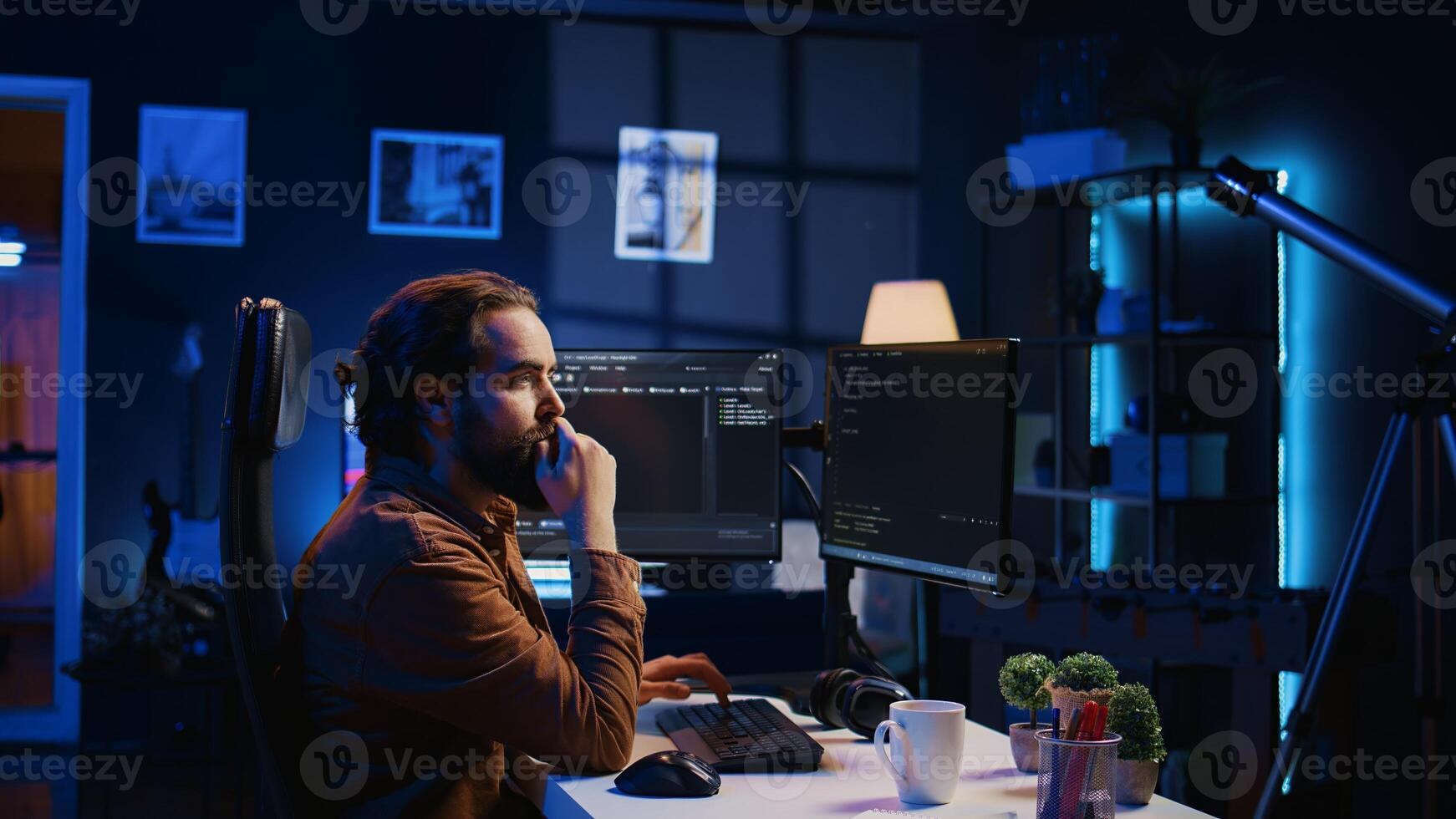 Software engineer doing programming using augmented reality visualization during remote job shift in home office. IT admin working on computer, looking at AR hologram, camera B photo