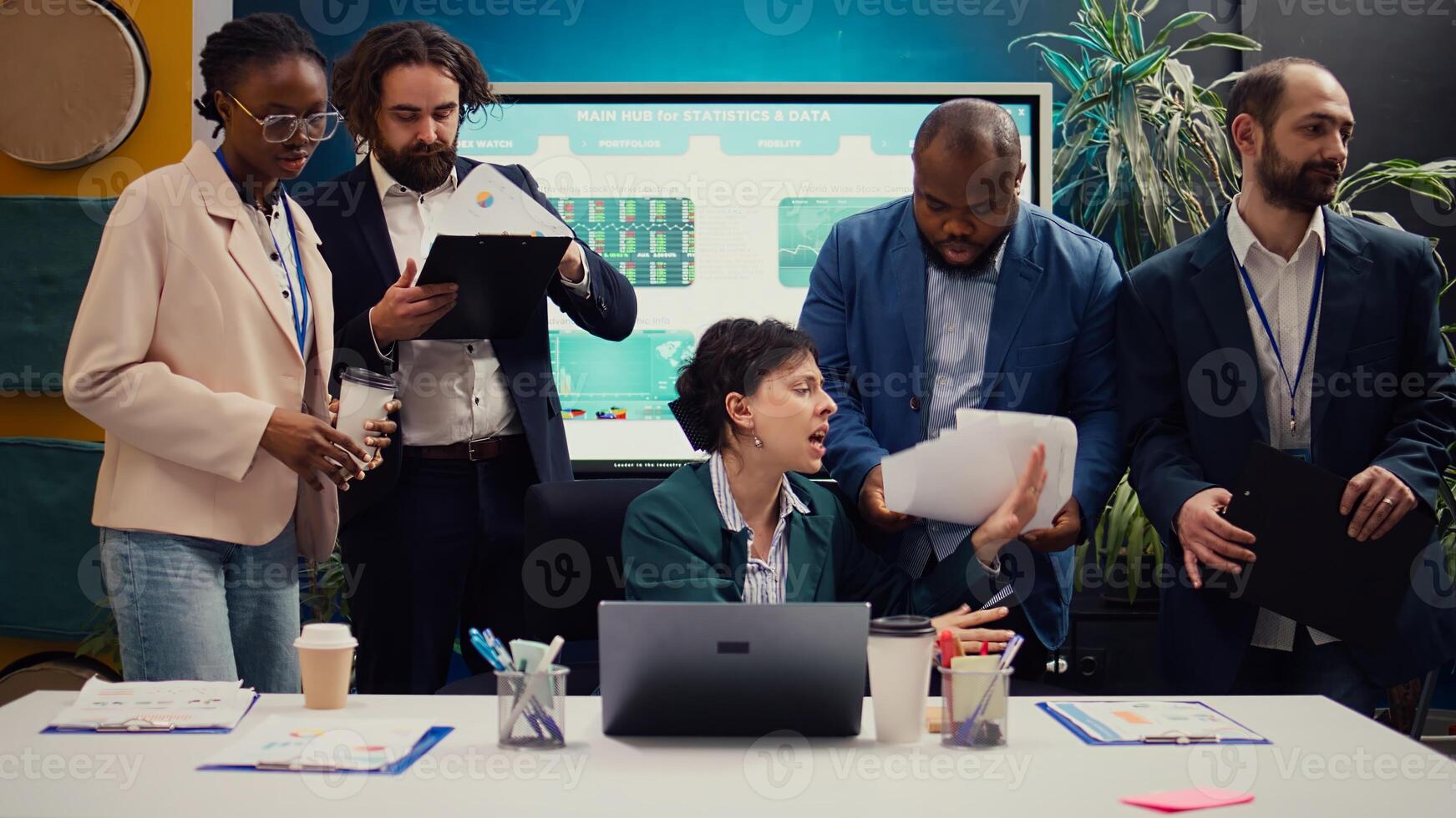 Irritated difficult boss getting angry at her employees team after not finishing the project before the deadline. Crazy manager yelling at her staff members and throwing papers. Camera B. photo