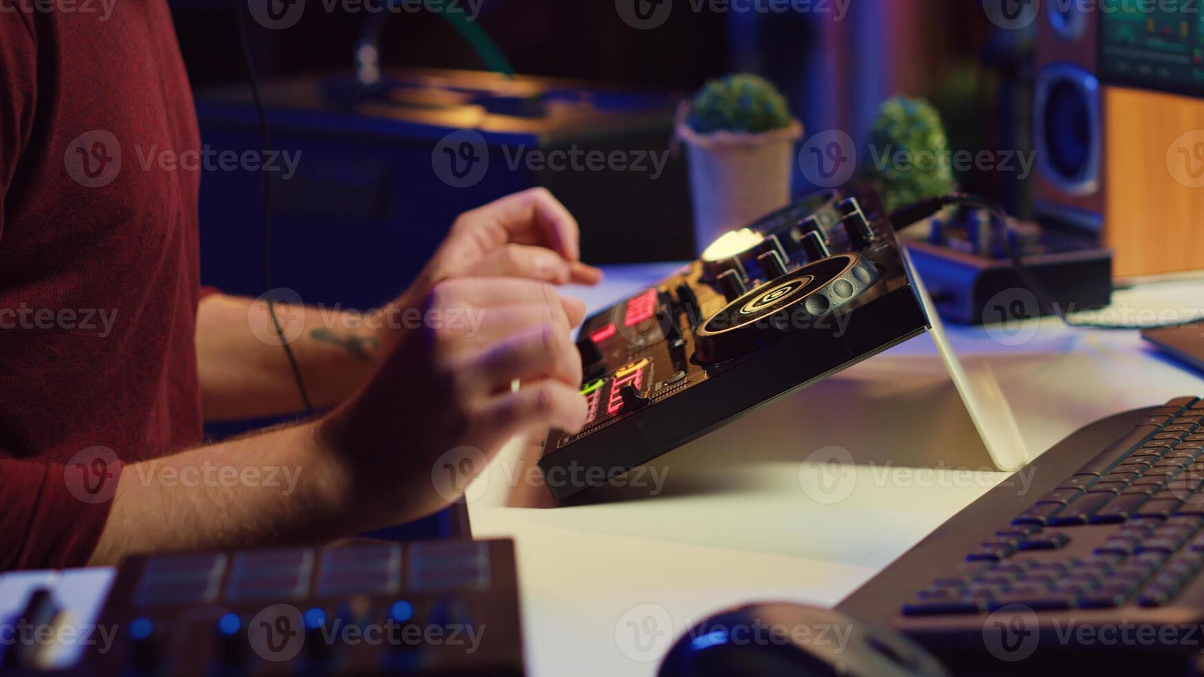 Music producer recording piano keyboard notes and editing them on a mixing console in his home studio. Skilled artist implementing advanced sound mixing techniques, equalization tools. Camera A. photo