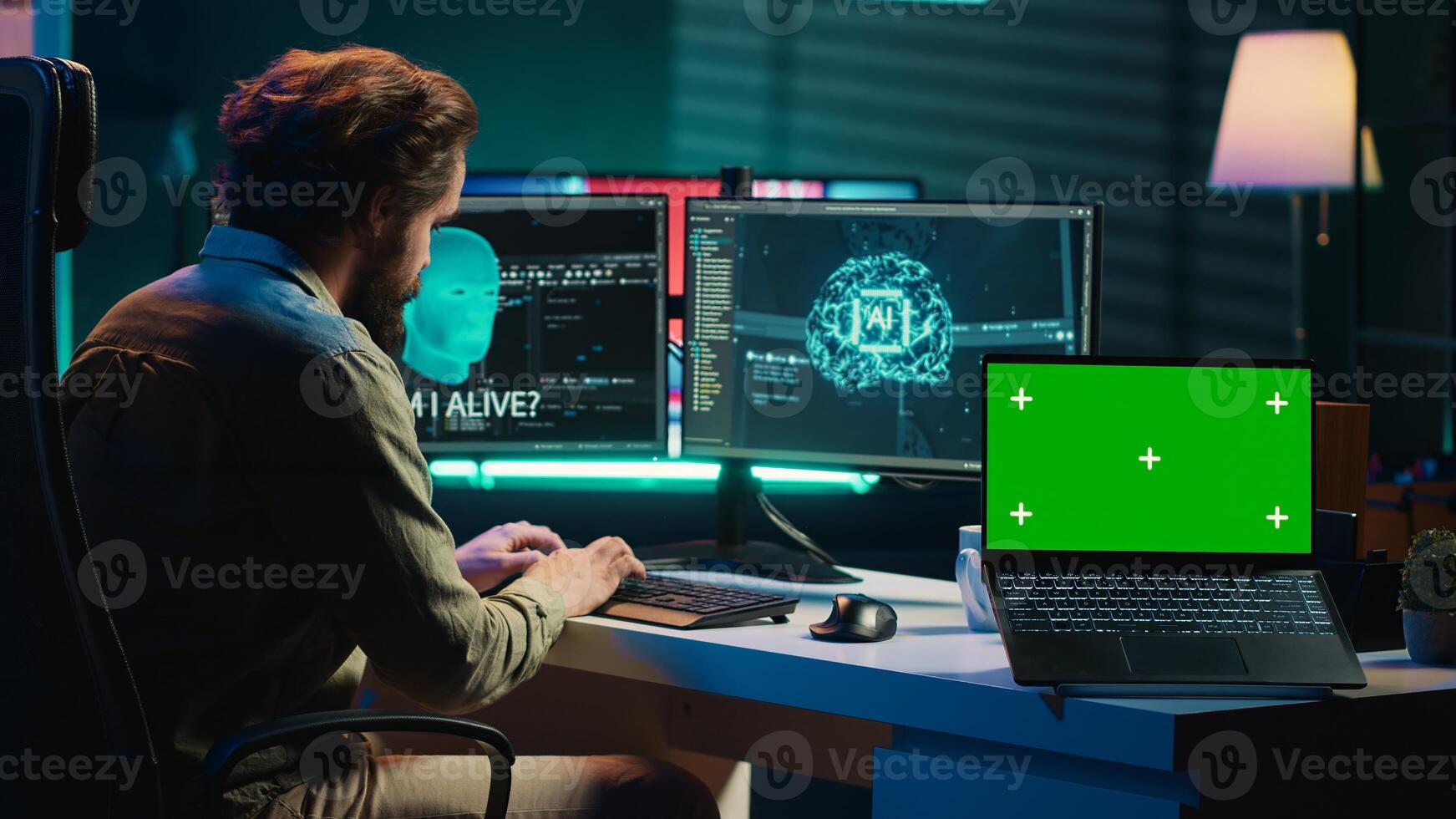 Programmer being asked existential questions by awaken AI gaining consciousness next to chroma key laptop. Man communicating with artificial intelligence through isolated screen device, camera A photo