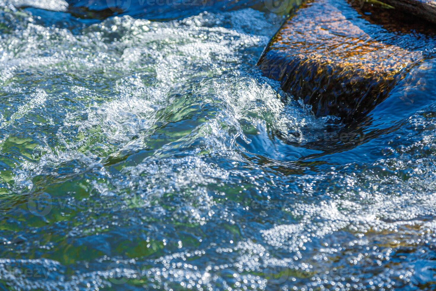flow of water and spray from a stone photo