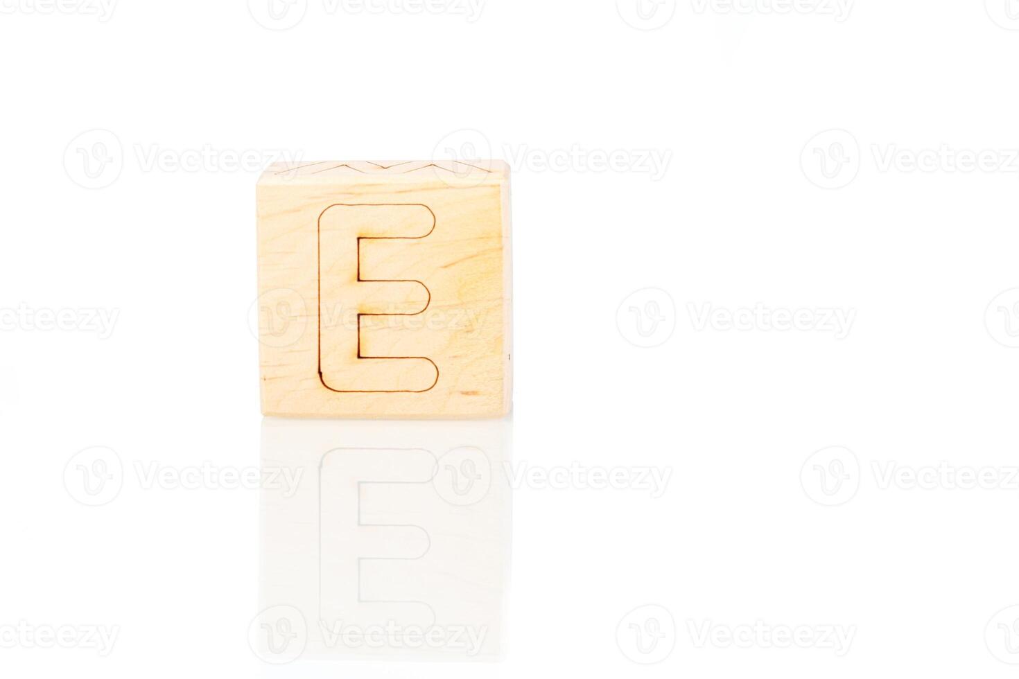 Wooden cubes with letters E on a white background photo