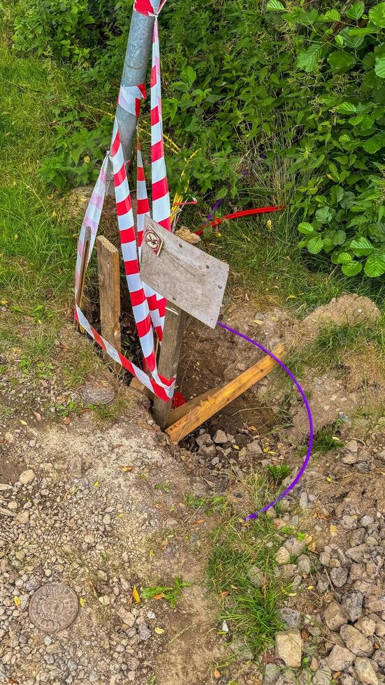 the pit was fenced off with red and white striped tape during the renovation photo