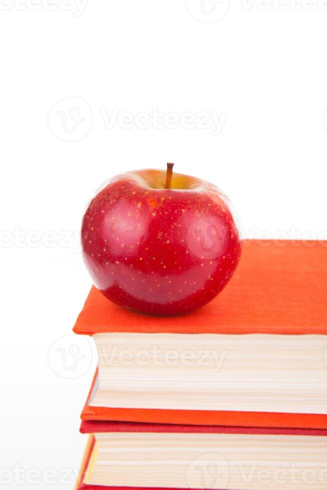 stack of books with red apple photo