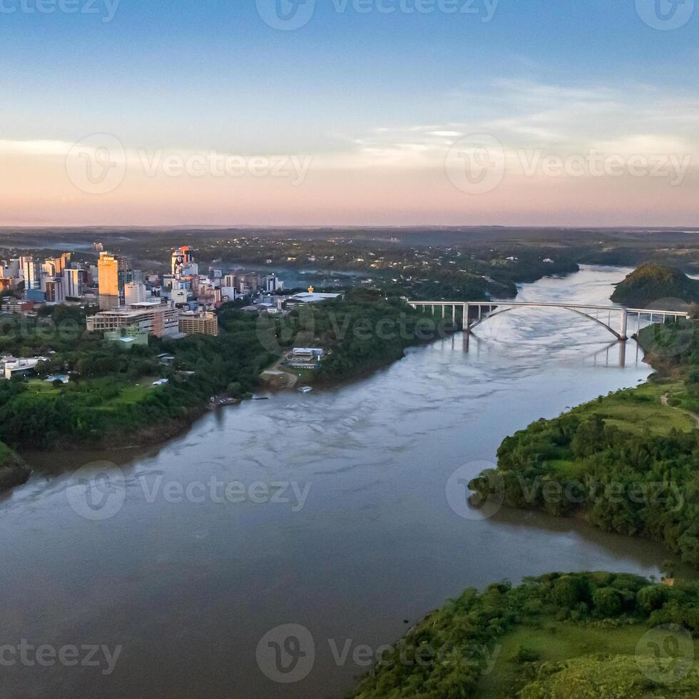 Border between Brazil and Paraguay and connects Foz do Iguacu to Ciudad del Este. Ponte da Amizade in Foz do Iguacu. Aerial view of the Friendship Bridge with Parana river. Square image. photo