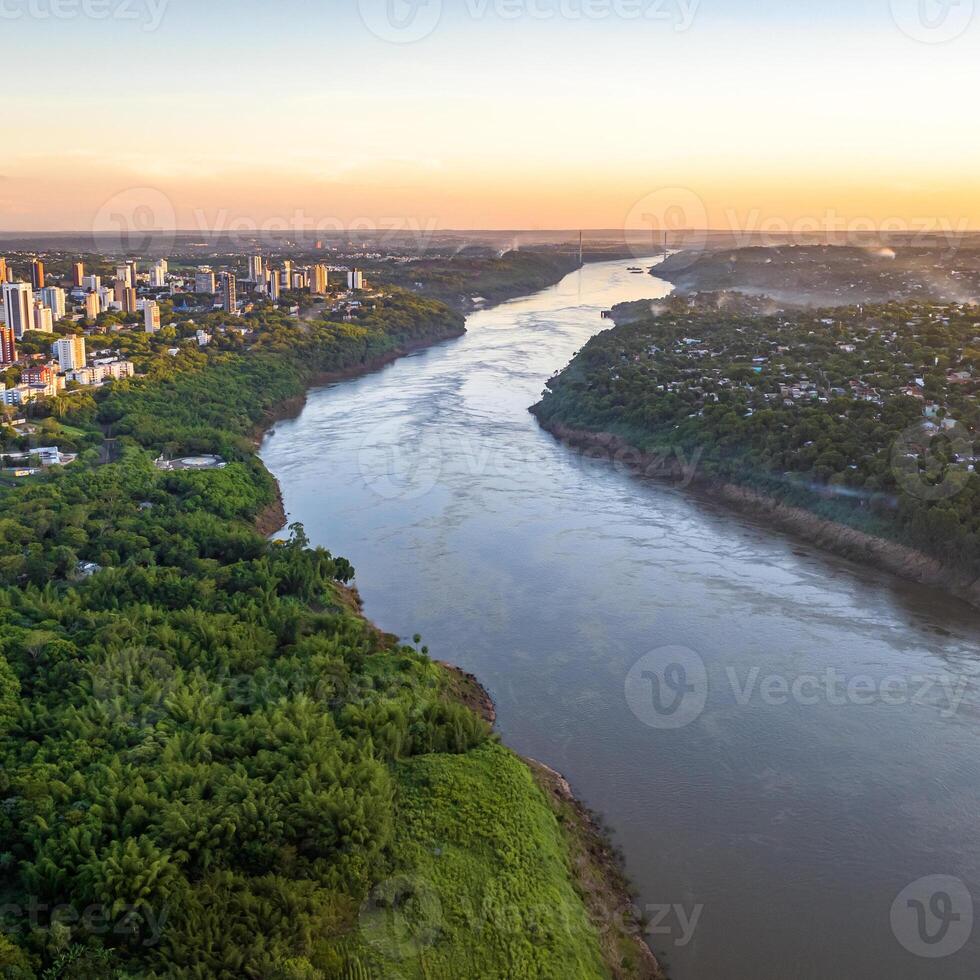 Border between Brazil and Paraguay and connects Foz do Iguacu to Ciudad del Este. Ponte da Amizade in Foz do Iguacu. Aerial view of the Friendship Bridge with Parana river. Square image. photo