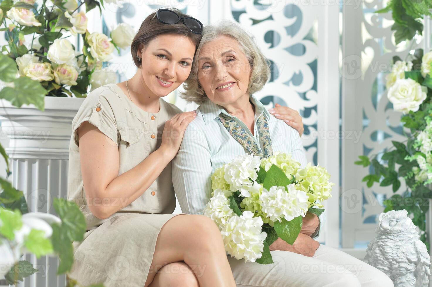 Portrait of a cute two happy women hugging photo