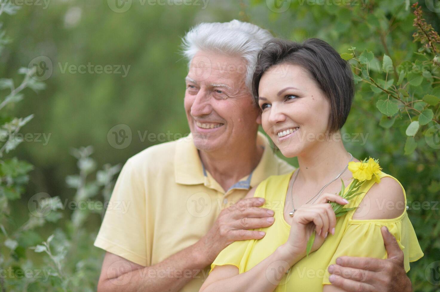 Happy adult daughter and elderly father in park photo
