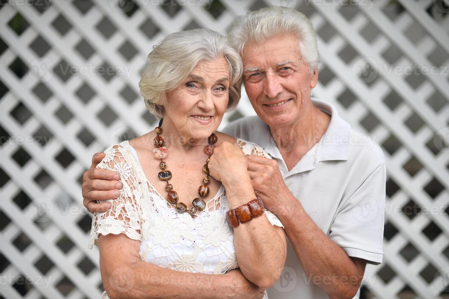Portrait of elderly couple posing in nature in summer photo