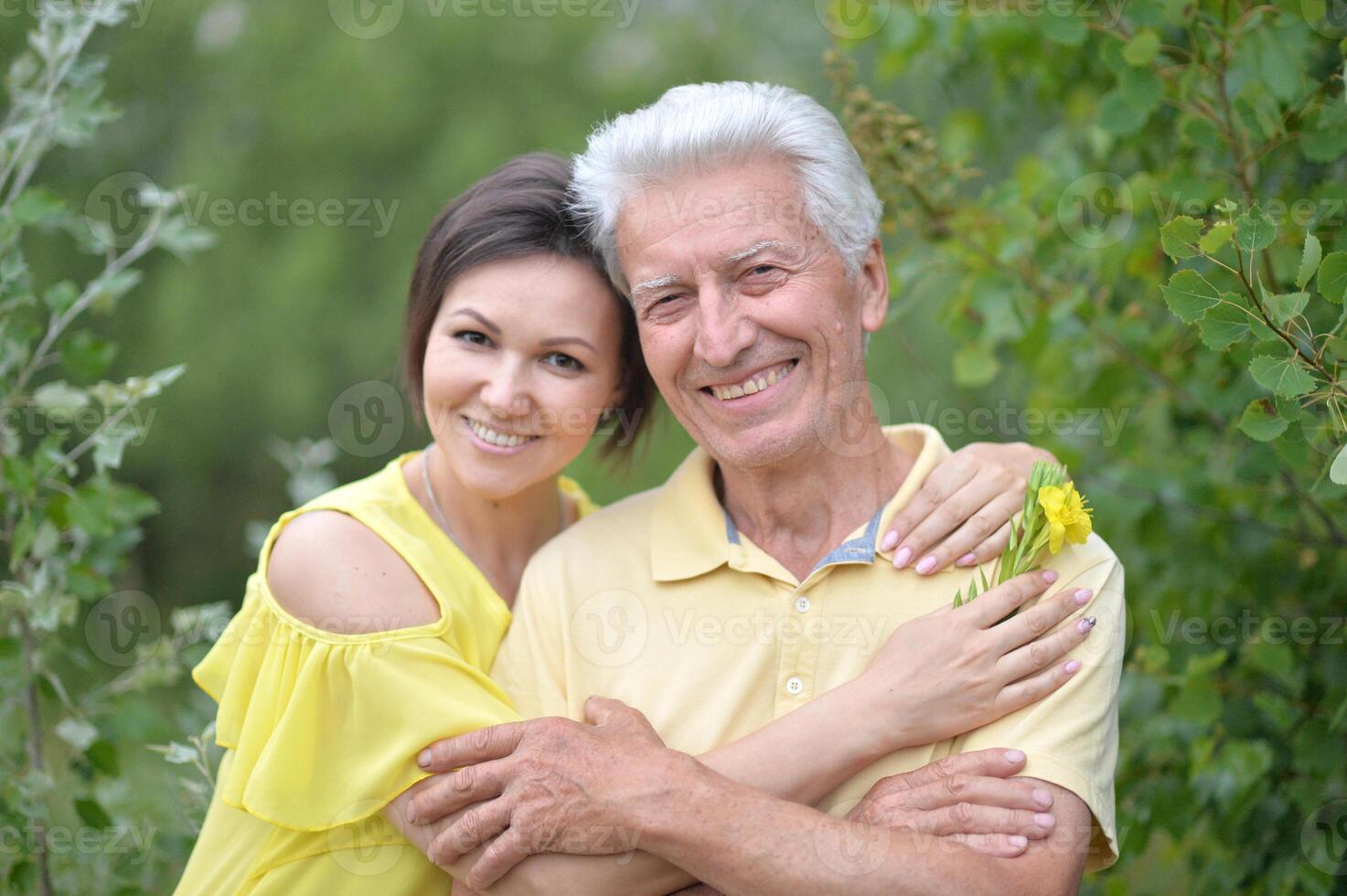 Happy adult daughter and elderly father in park photo