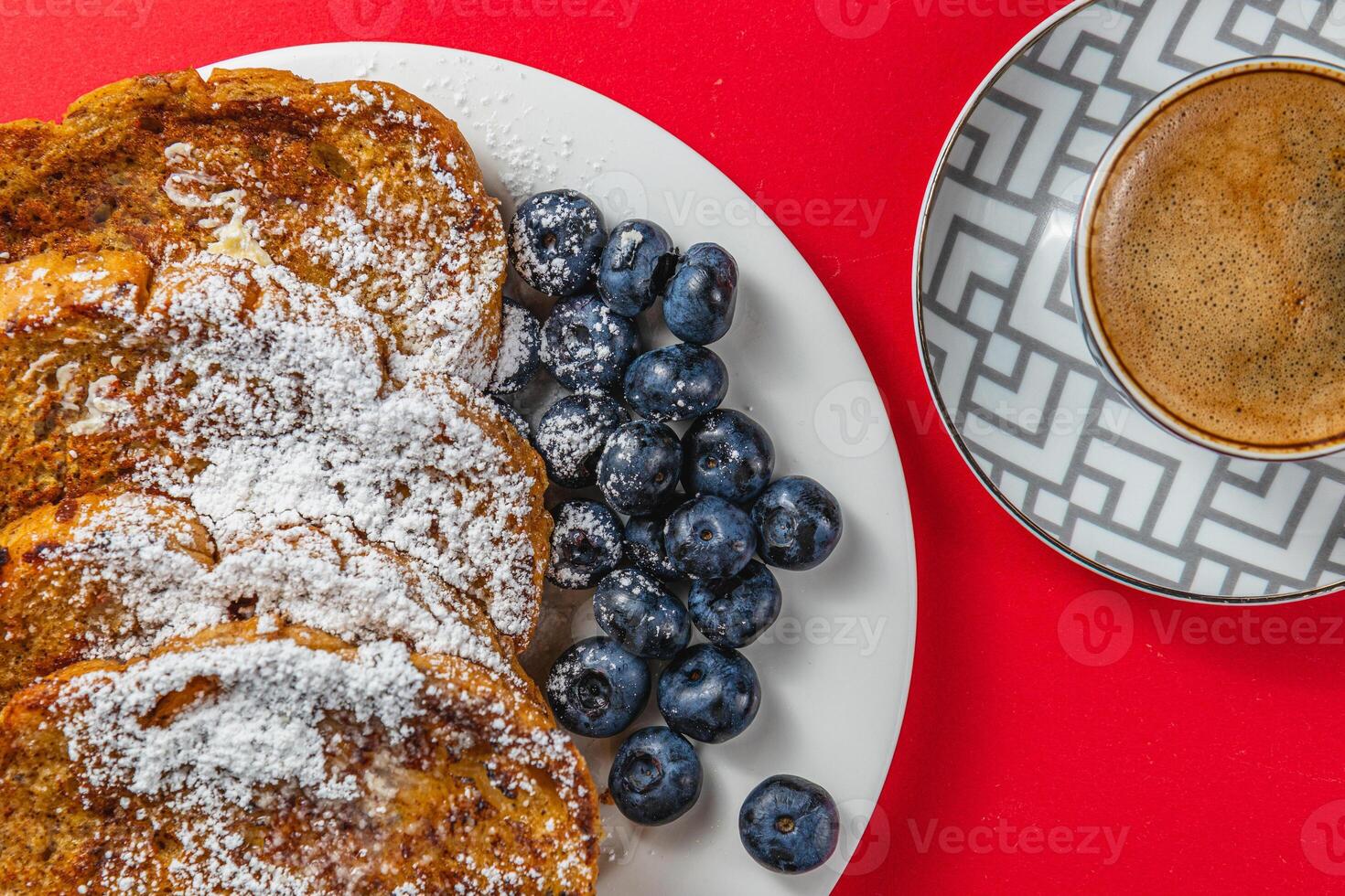 French toast on a white plate with blueberries and coffee for breakfast photo