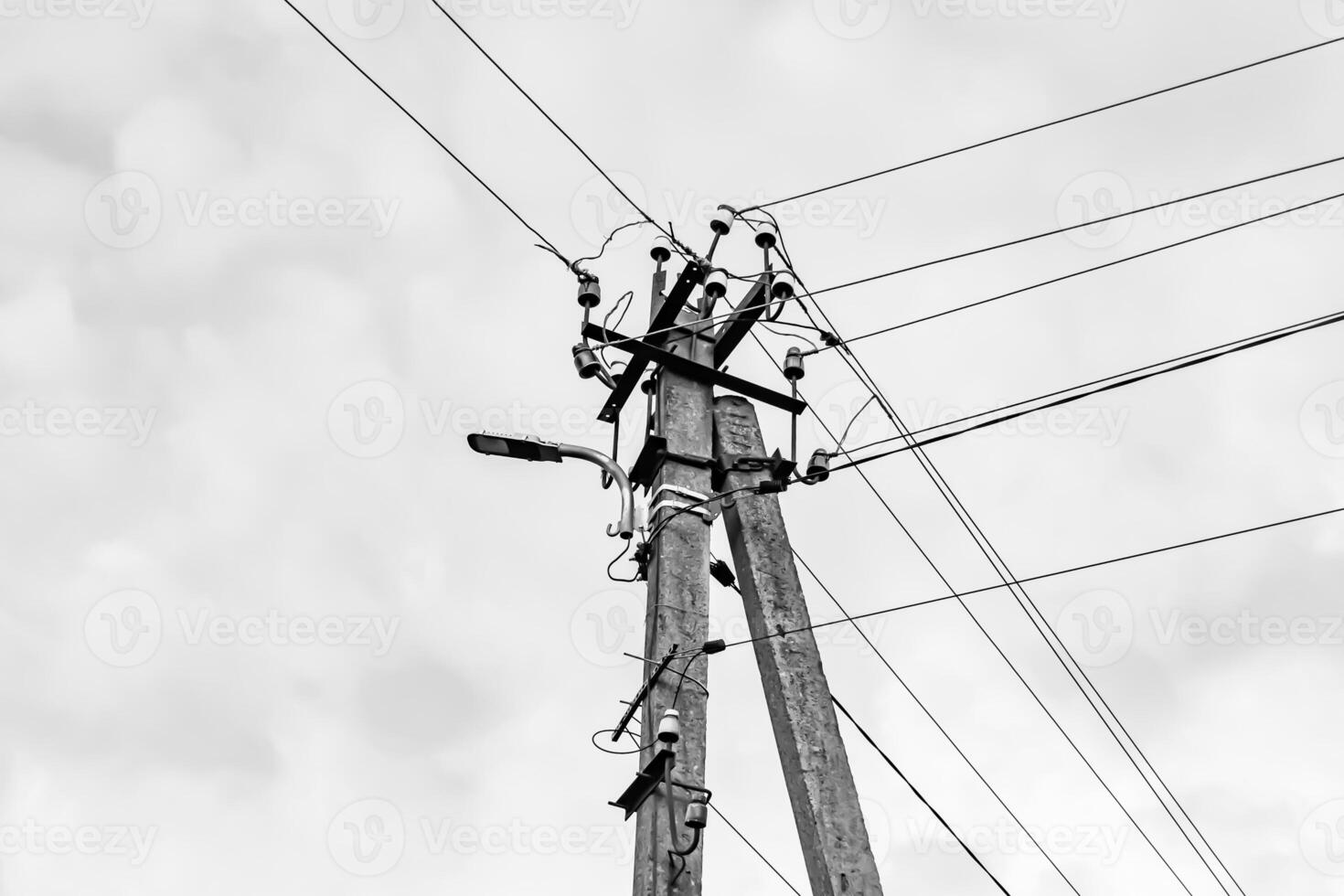 Power electric pole with line wire on light background close up photo