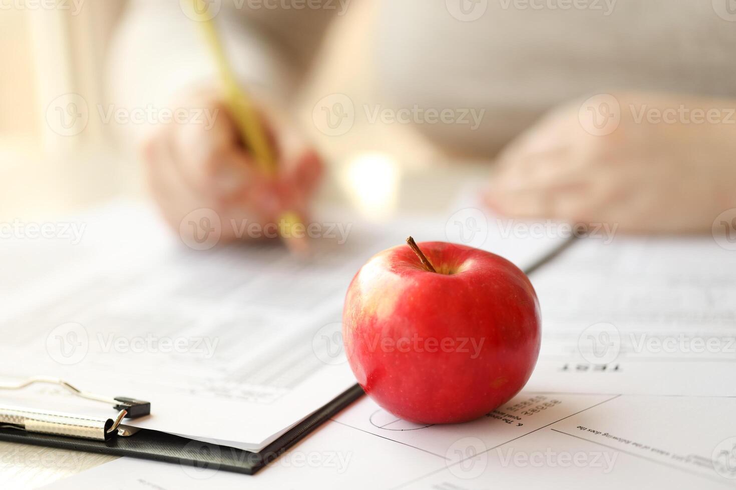 Female student hands testing in exercise and taking fill in exam paper sheet with pencil at school test photo