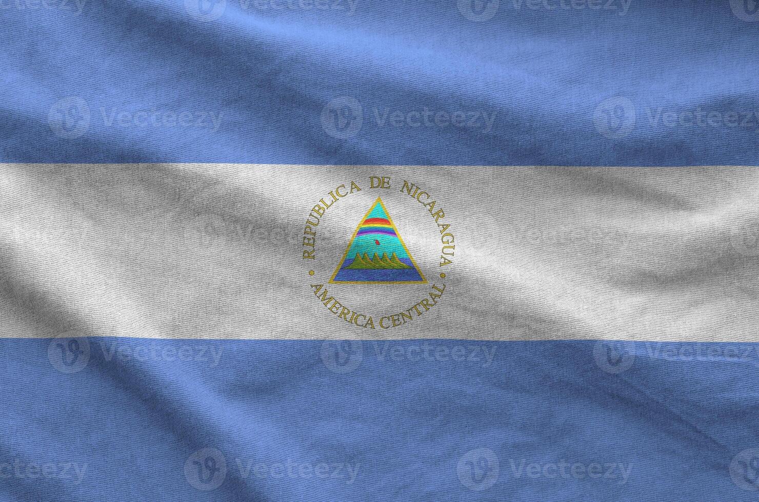 Nicaragua flag depicted on folded wavy fabric of old cloth photo