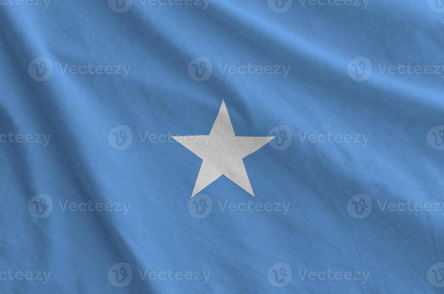 Somalia flag depicted on folded wavy fabric of old cloth photo