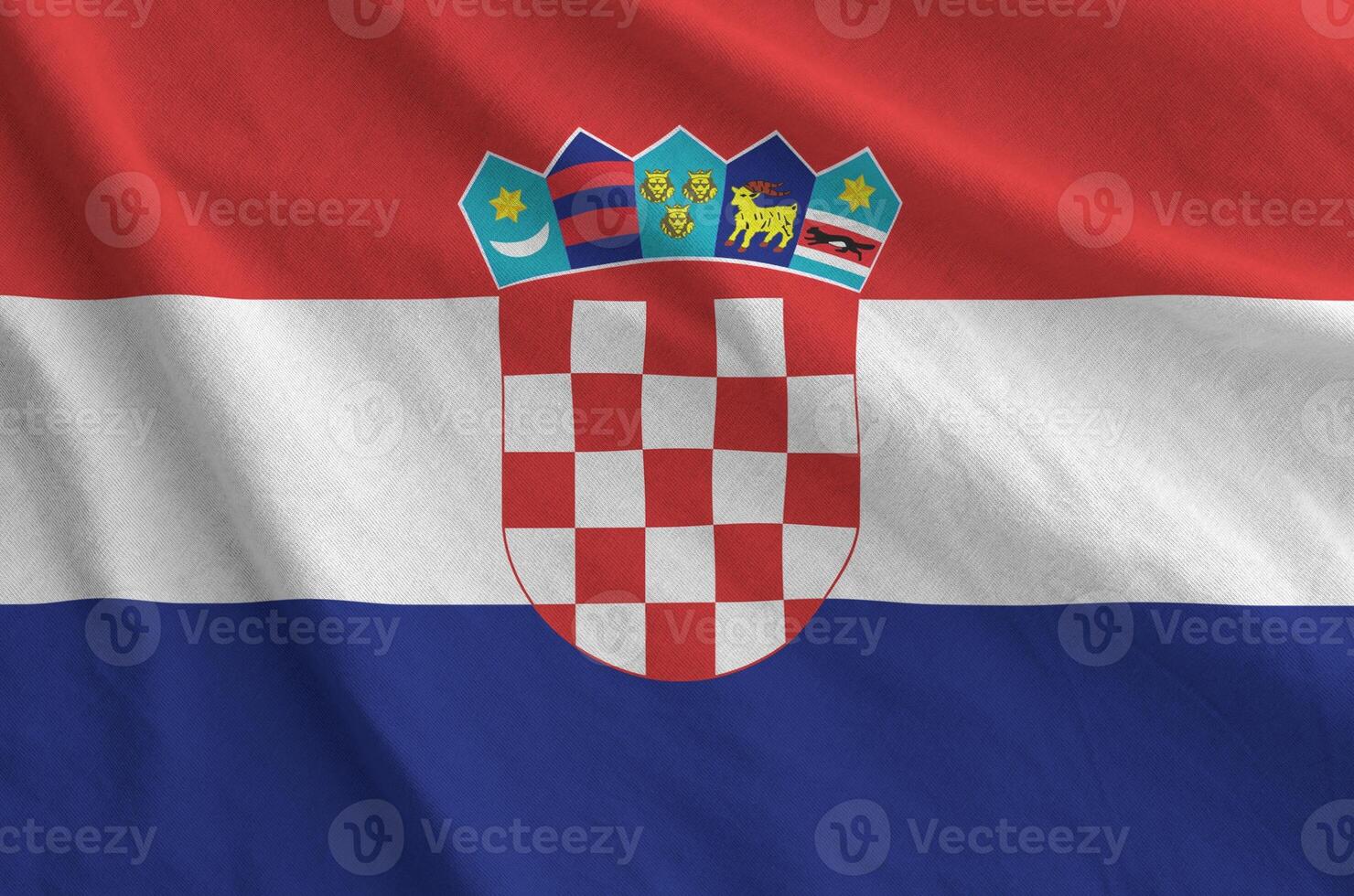 Croatia flag depicted on folded wavy fabric of old cloth photo