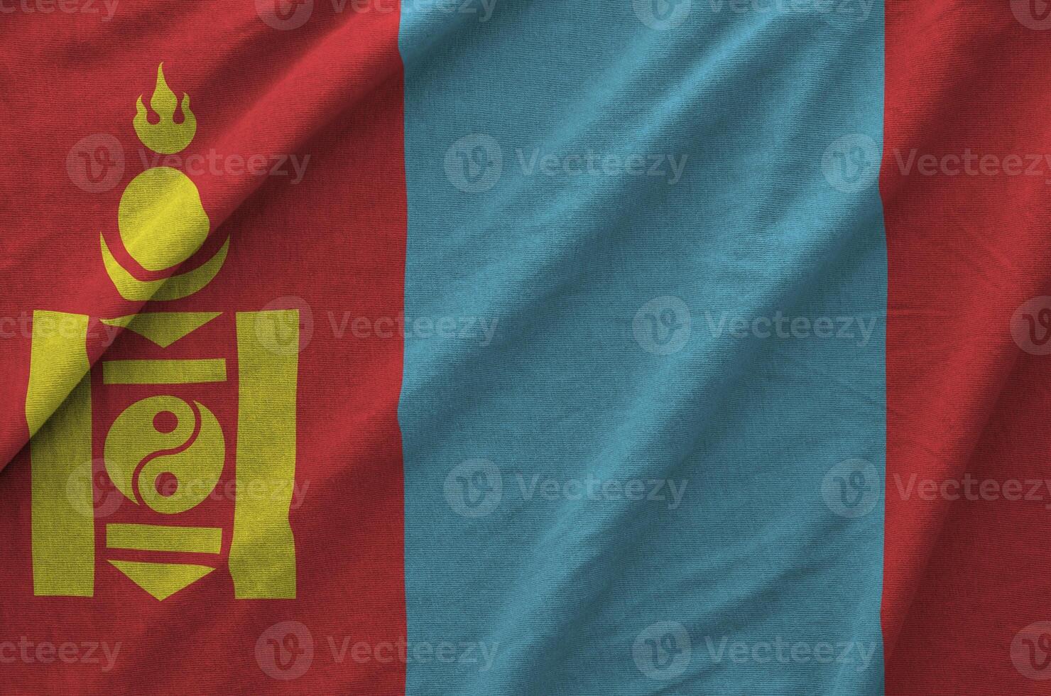 Mongolia flag depicted on folded wavy fabric of old cloth photo