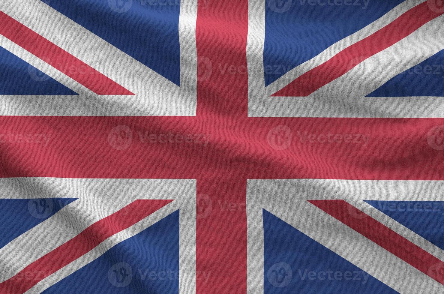 Great britain flag depicted on folded wavy fabric of old cloth photo
