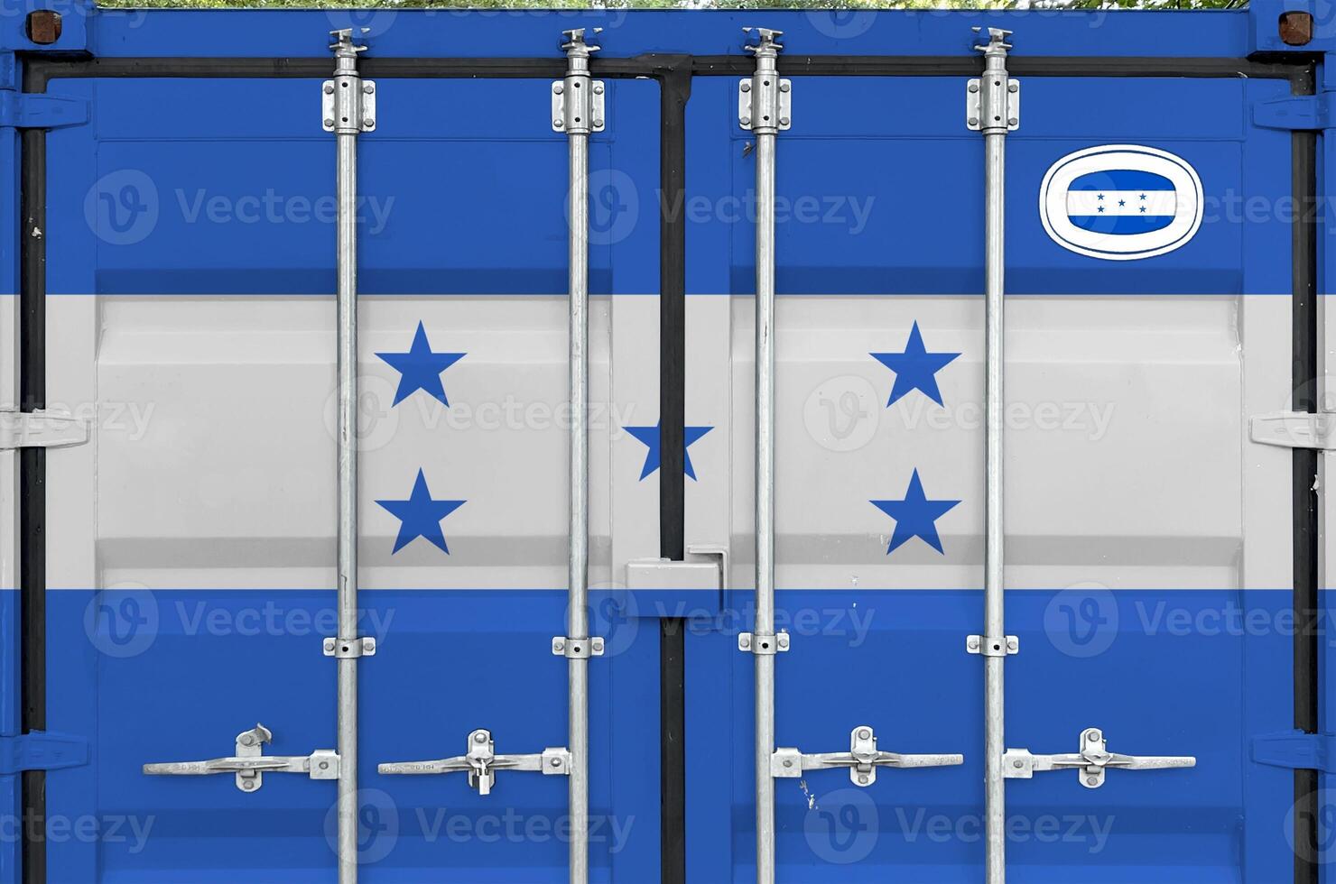 Honduras flag depicted on metal doors of shipping cargo container outdoors in docks area photo