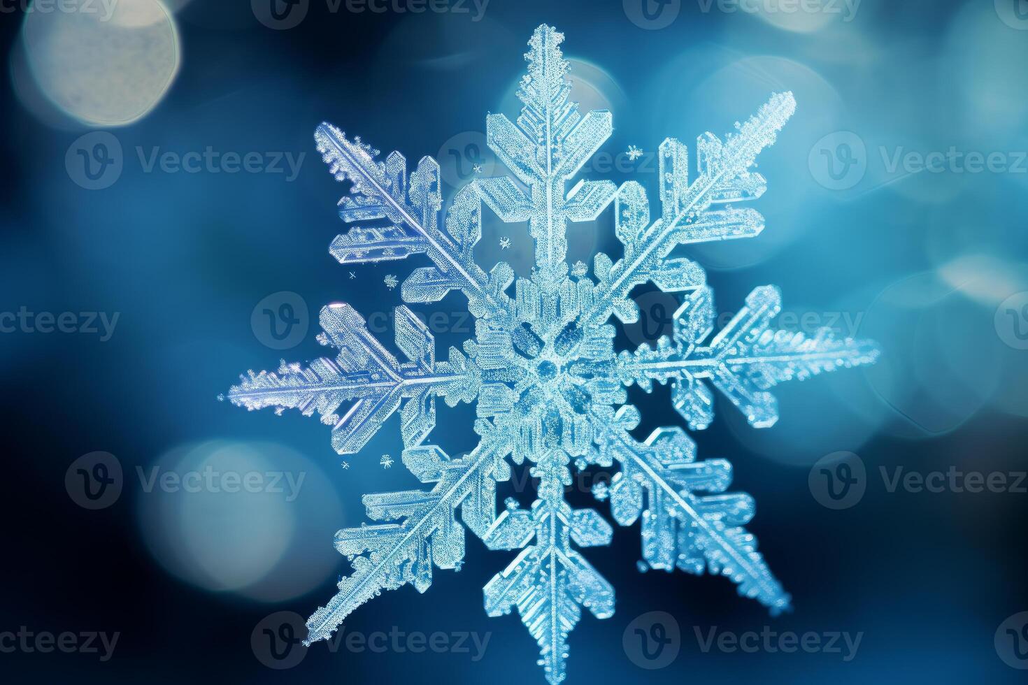 Exquisite macro snowflake on blue background photo