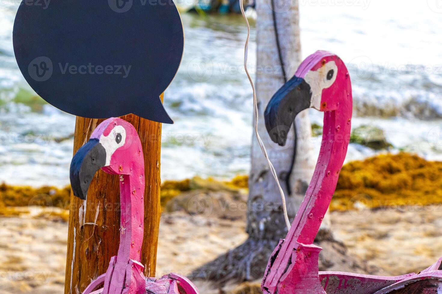 Pink flamingo decorative figure on the beach statue Mexico. photo