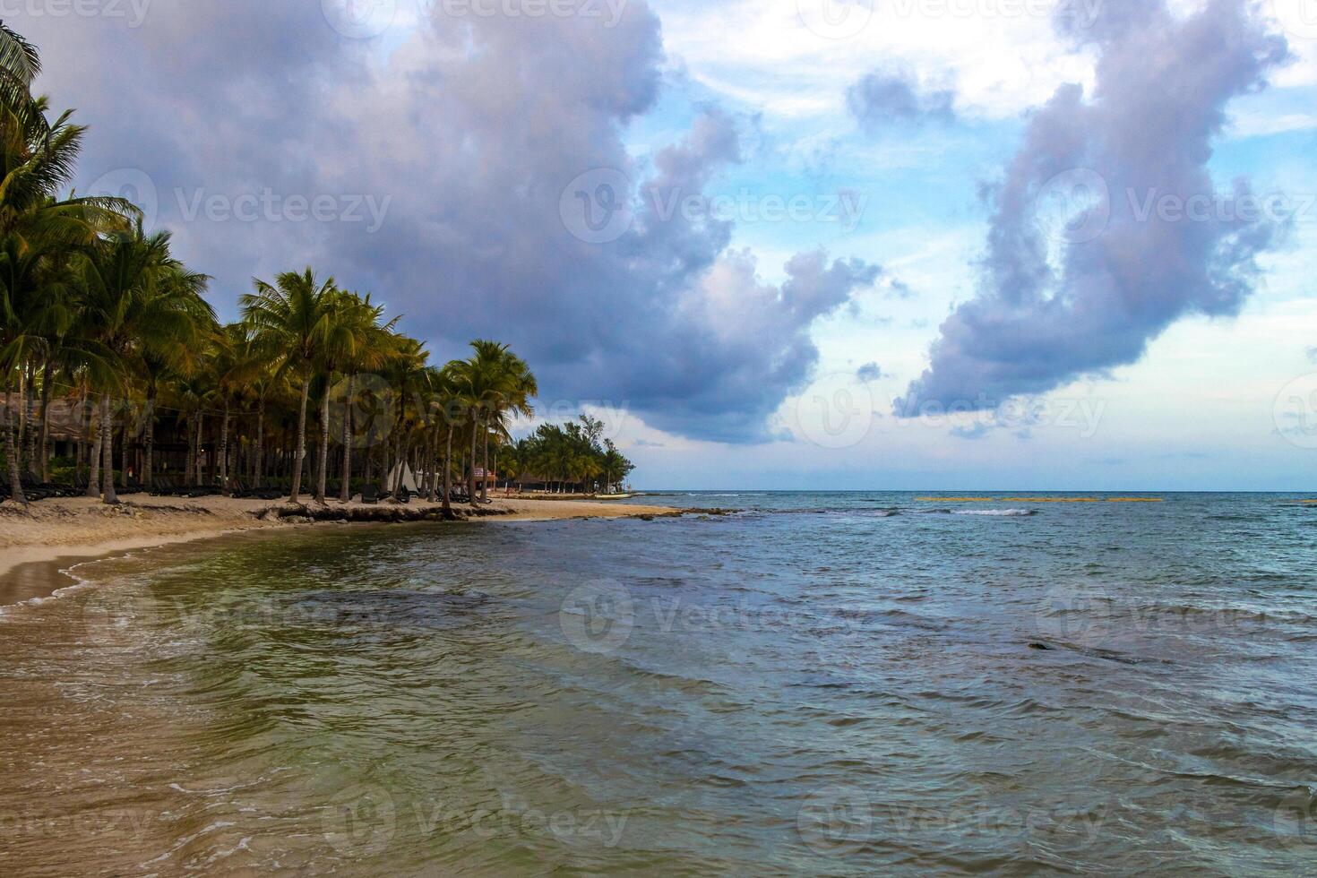 Tropical Caribbean beach people parasols fun Playa del Carmen Mexico. photo