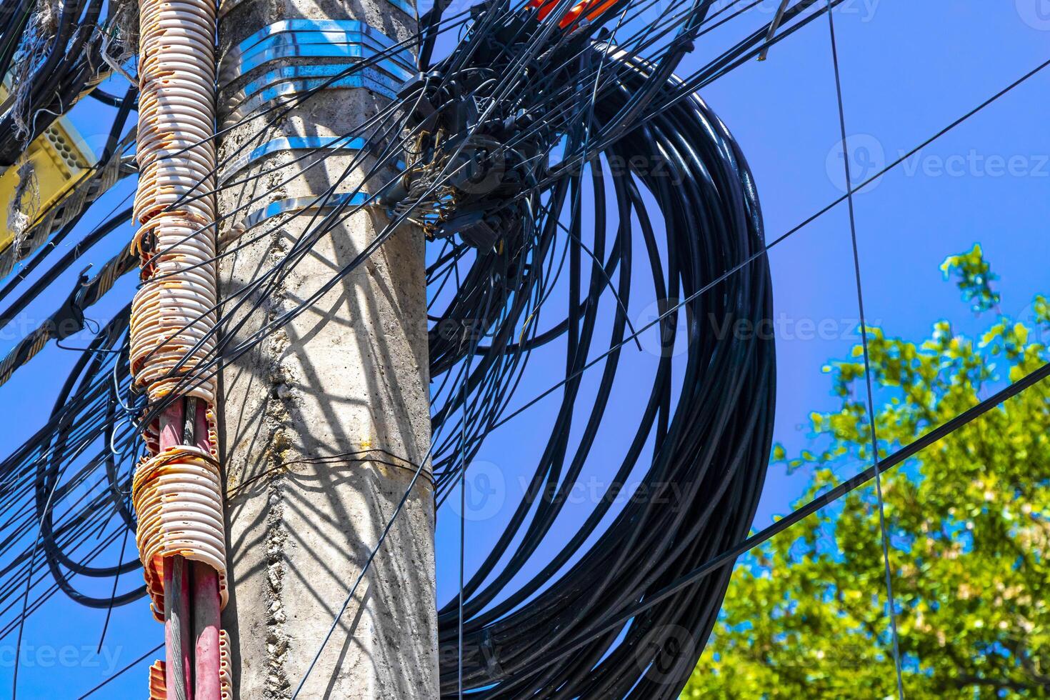 Absolute cable chaos on mexican power pole in Mexico. photo