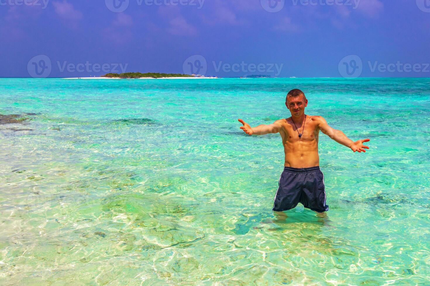 Male tourist man vacation on island Madivaru Finolhu Rasdhoo Maldives. photo