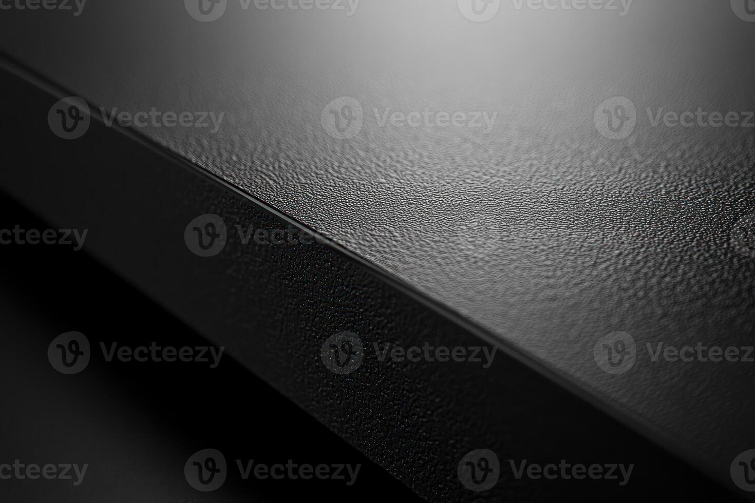 Close-up of a Black Textured Surface with a Diagonal Edge photo