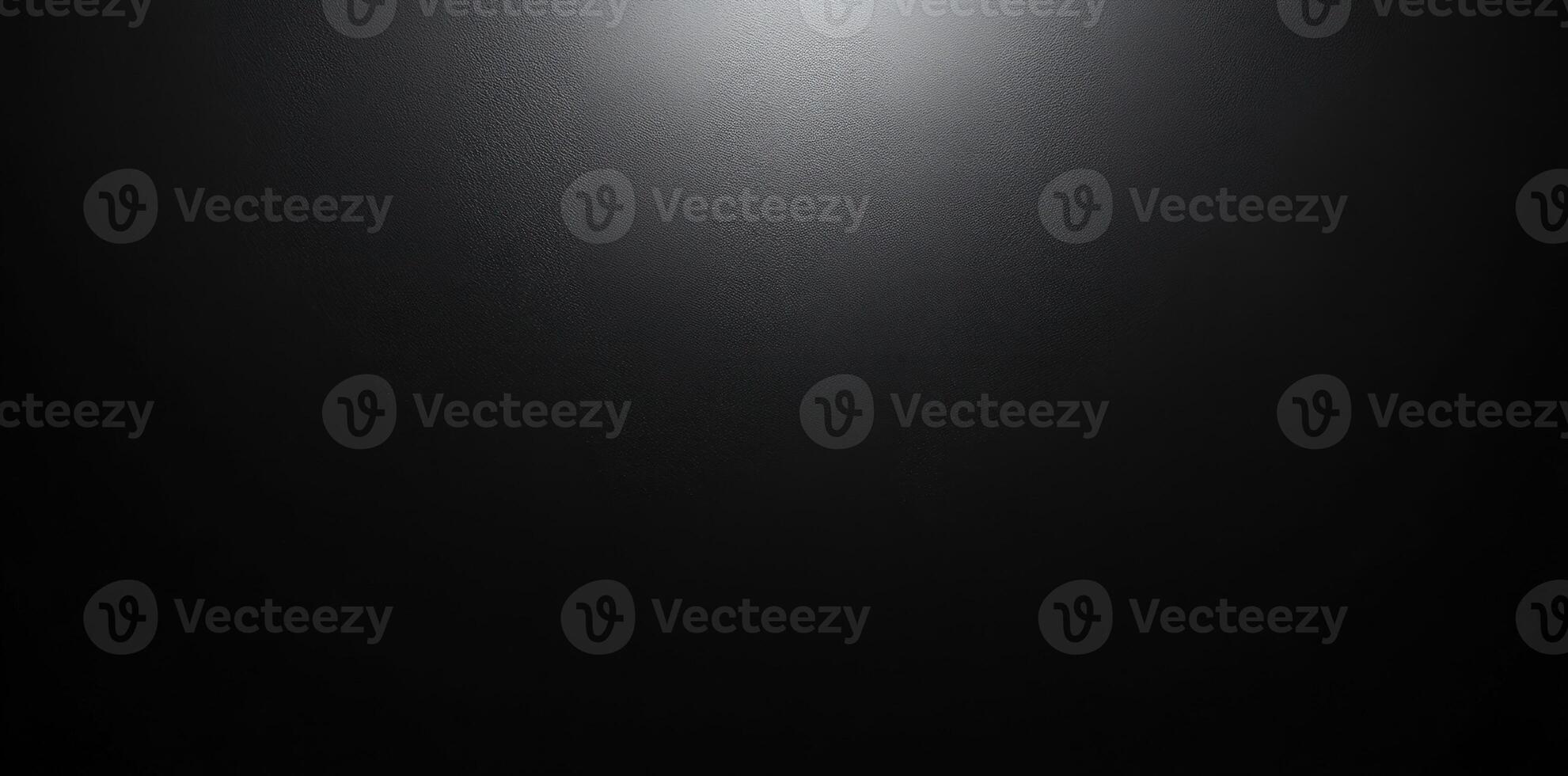 A Single Light Source Illuminating a Black, Textured Surface photo