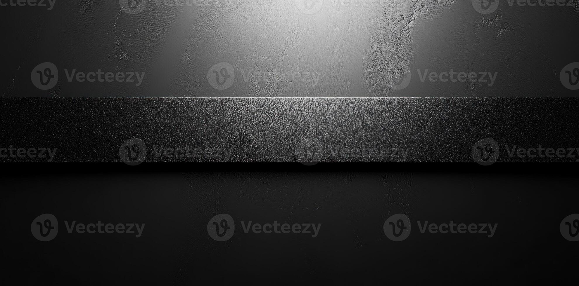 Black Textured Surface with a Horizontal Band and Overhead Lighting photo