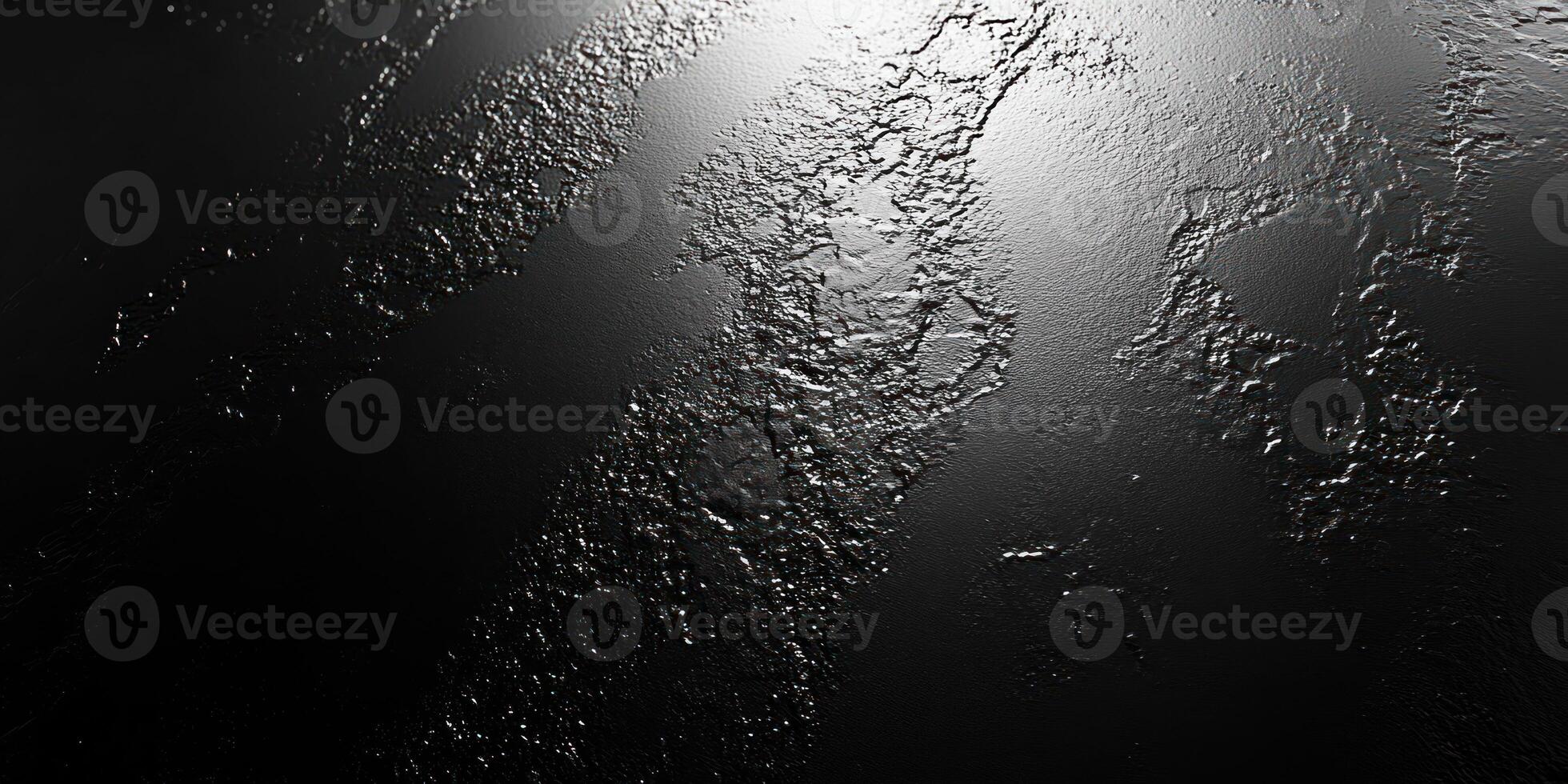 A Textured Black Surface with Light Reflecting on it photo