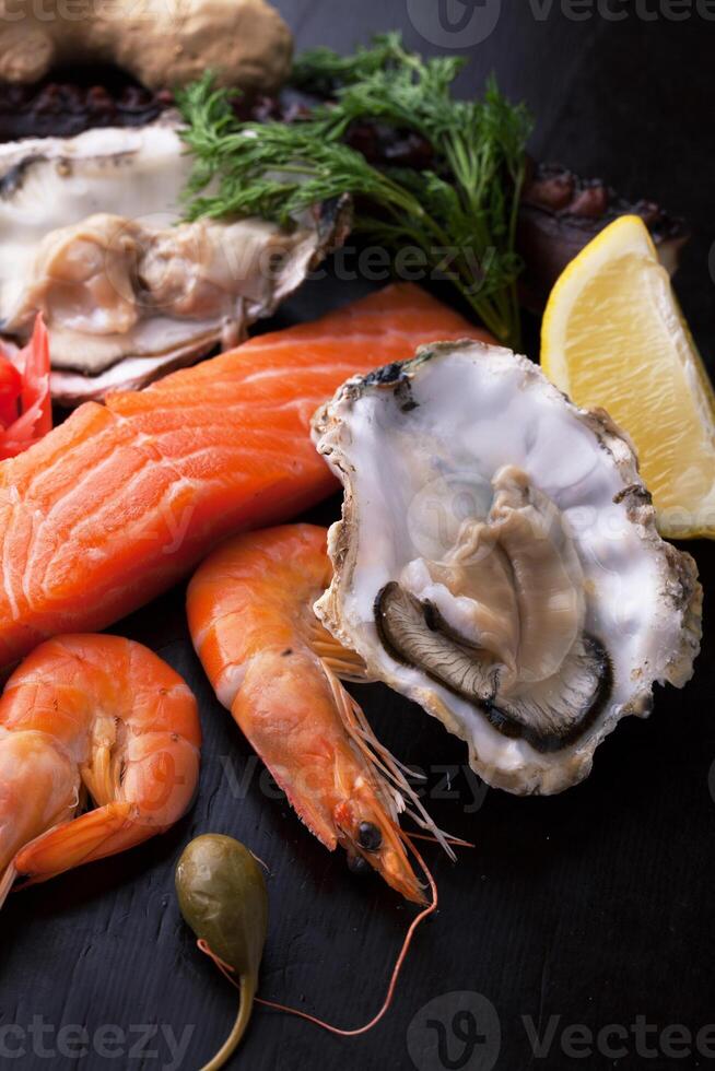 Fresh seafood with lemon, capers and thyme photo