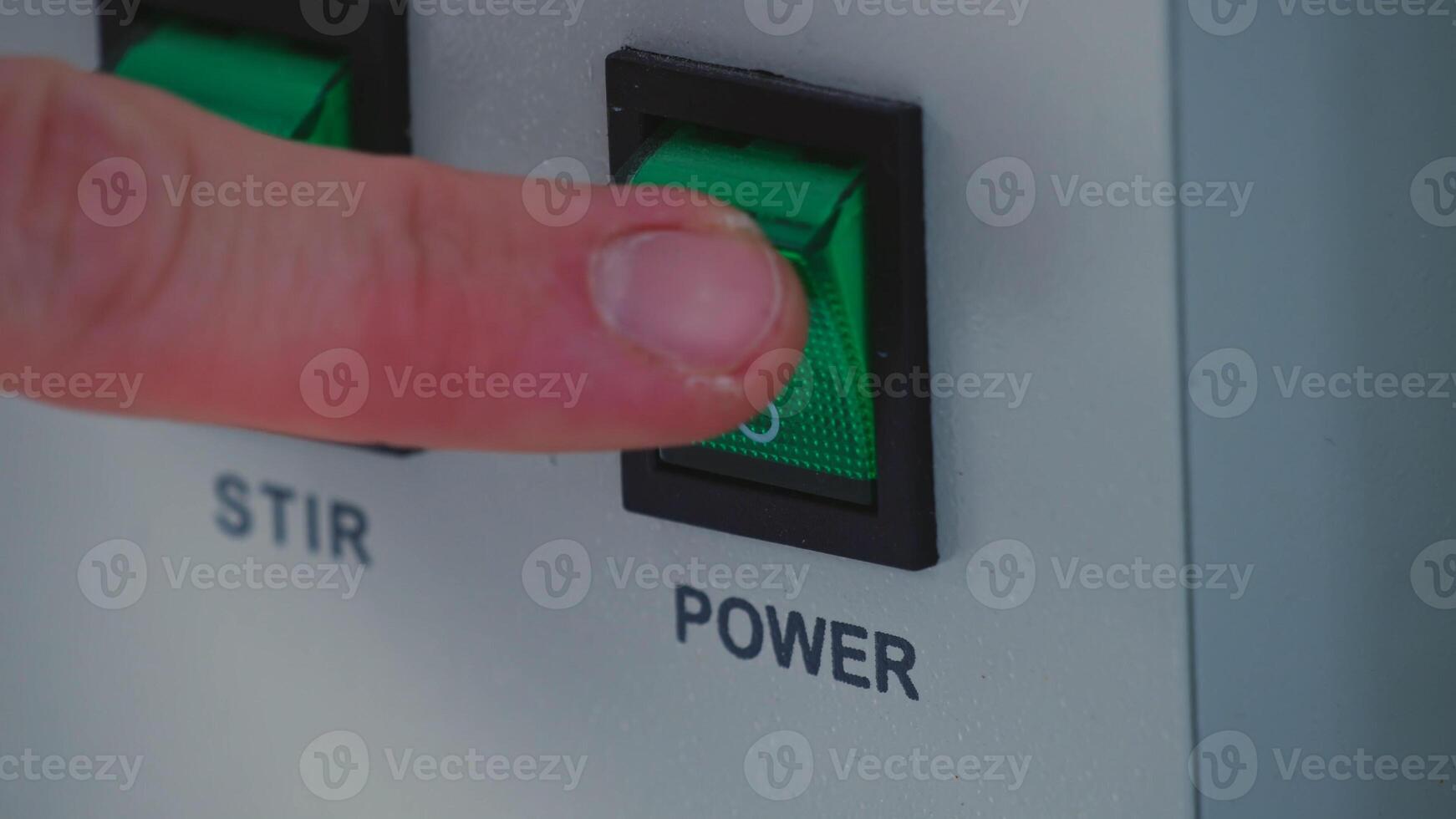 the man finger press the button control on modul operating machine to start machine. photo