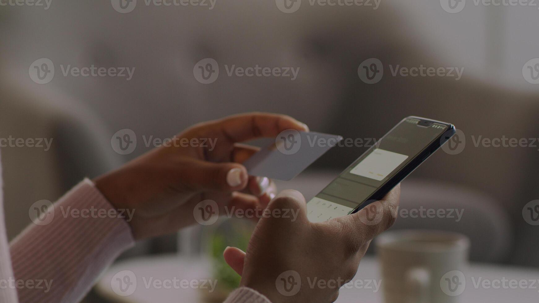 Hands holding credit card and using mobile smart phone photo