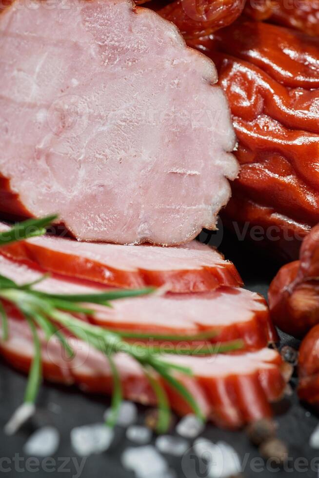 Cold cuts on a stone board. Sliced sausage photo