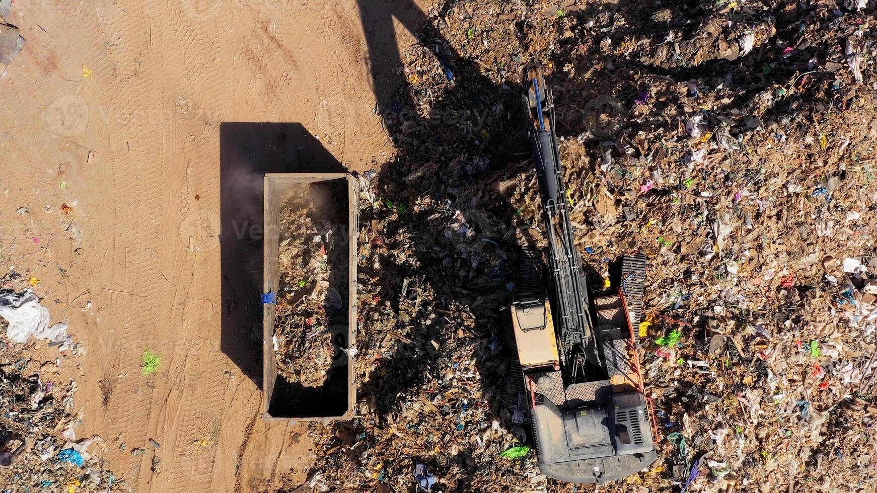 Industrial waste Sorting and Shipping landfill, With excavator and trailers loaded with various types of salvaged metals. photo