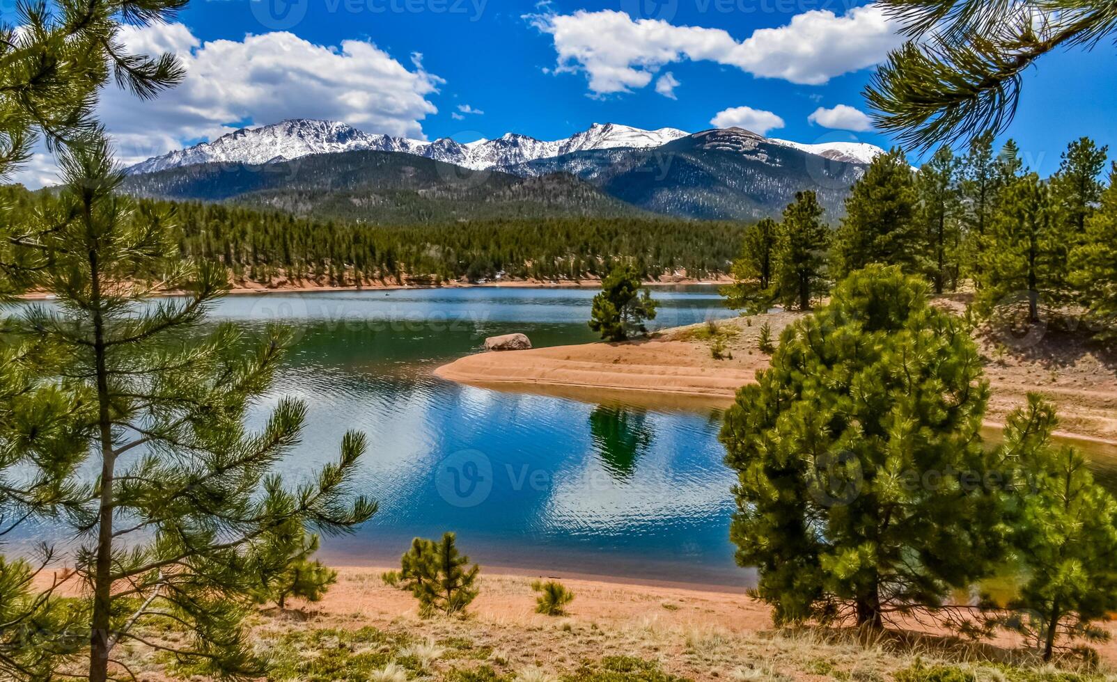 Panorama Snow-capped and forested mountains near a mountain lake, Pikes Peak Mountains in Colorado Spring, Colorado, US photo
