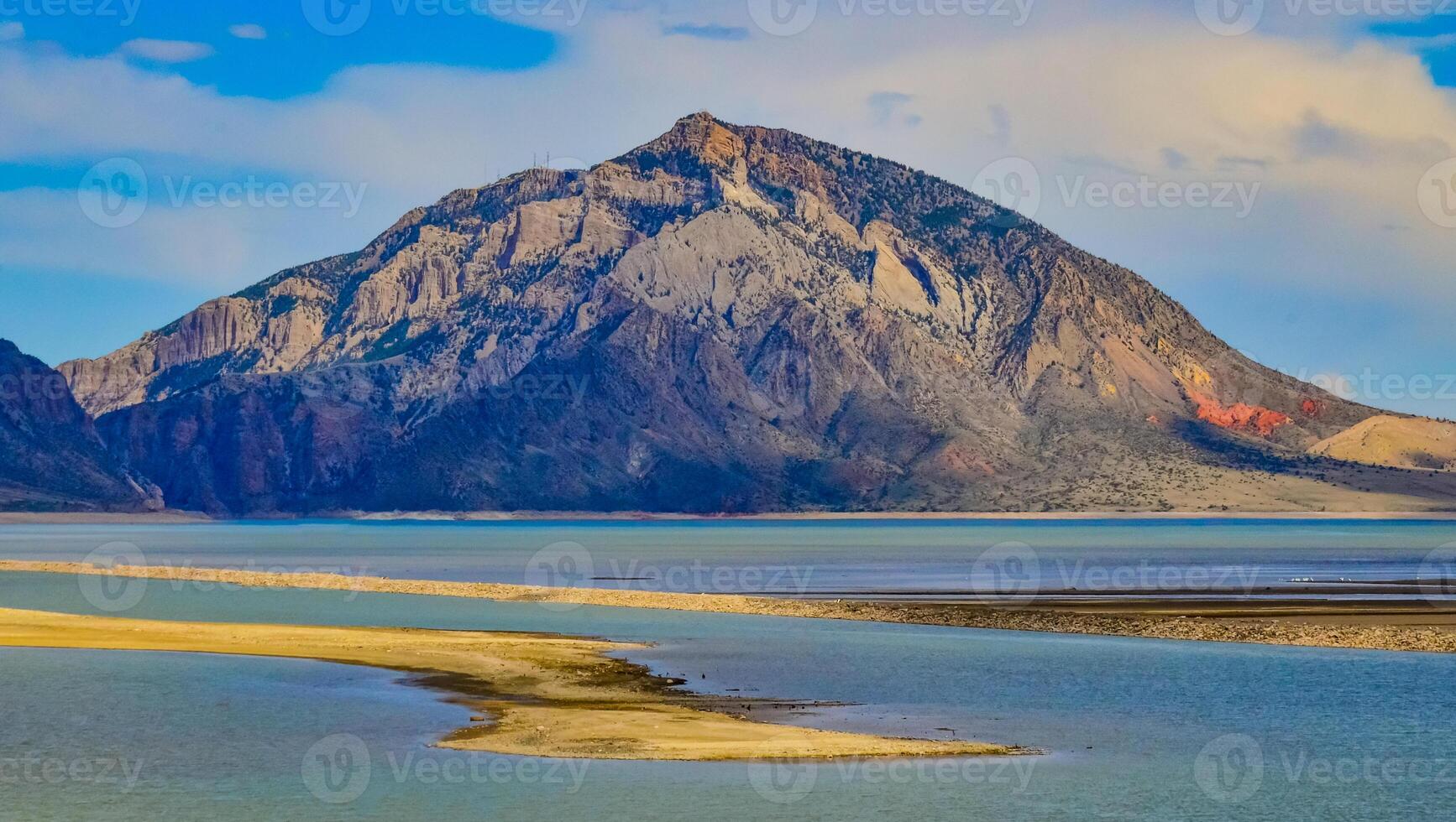 Mountain landscape, small lake with clear cold water in a valley among mountains in Montana photo