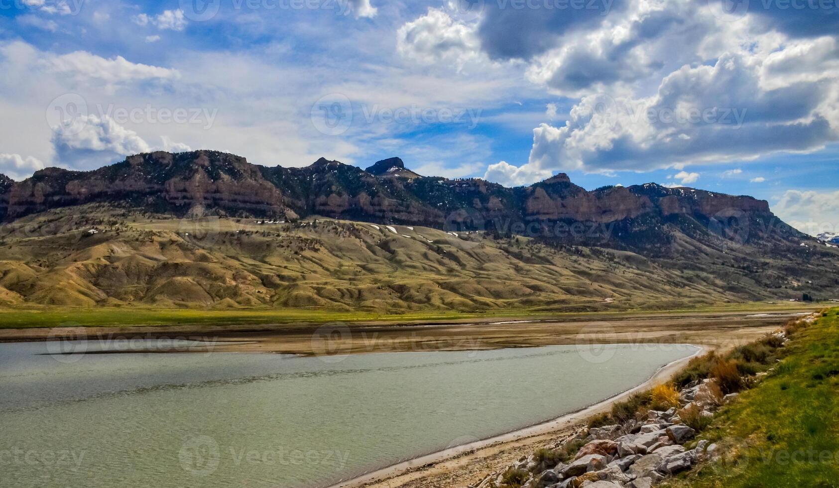 Mountain landscape, small lake with clear cold water in a valley among mountains in Montana photo