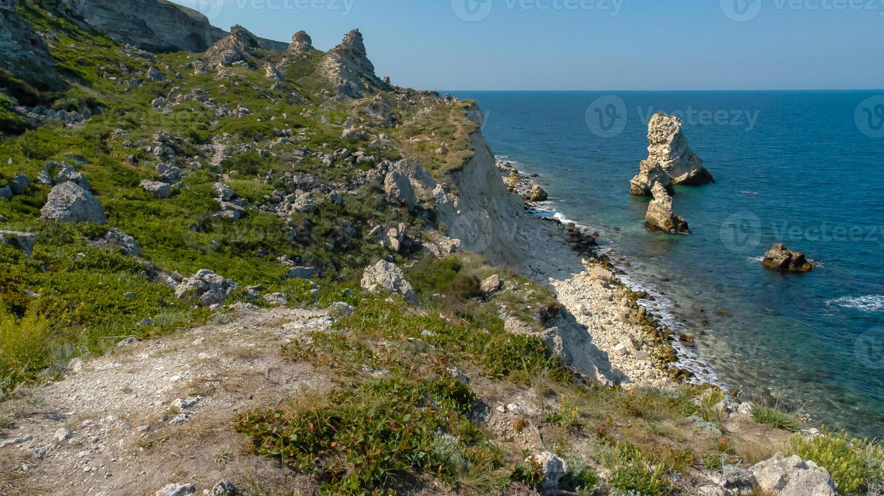 View of the steep banks and rocks in the water in the Dzhangul tract, western Crimea photo