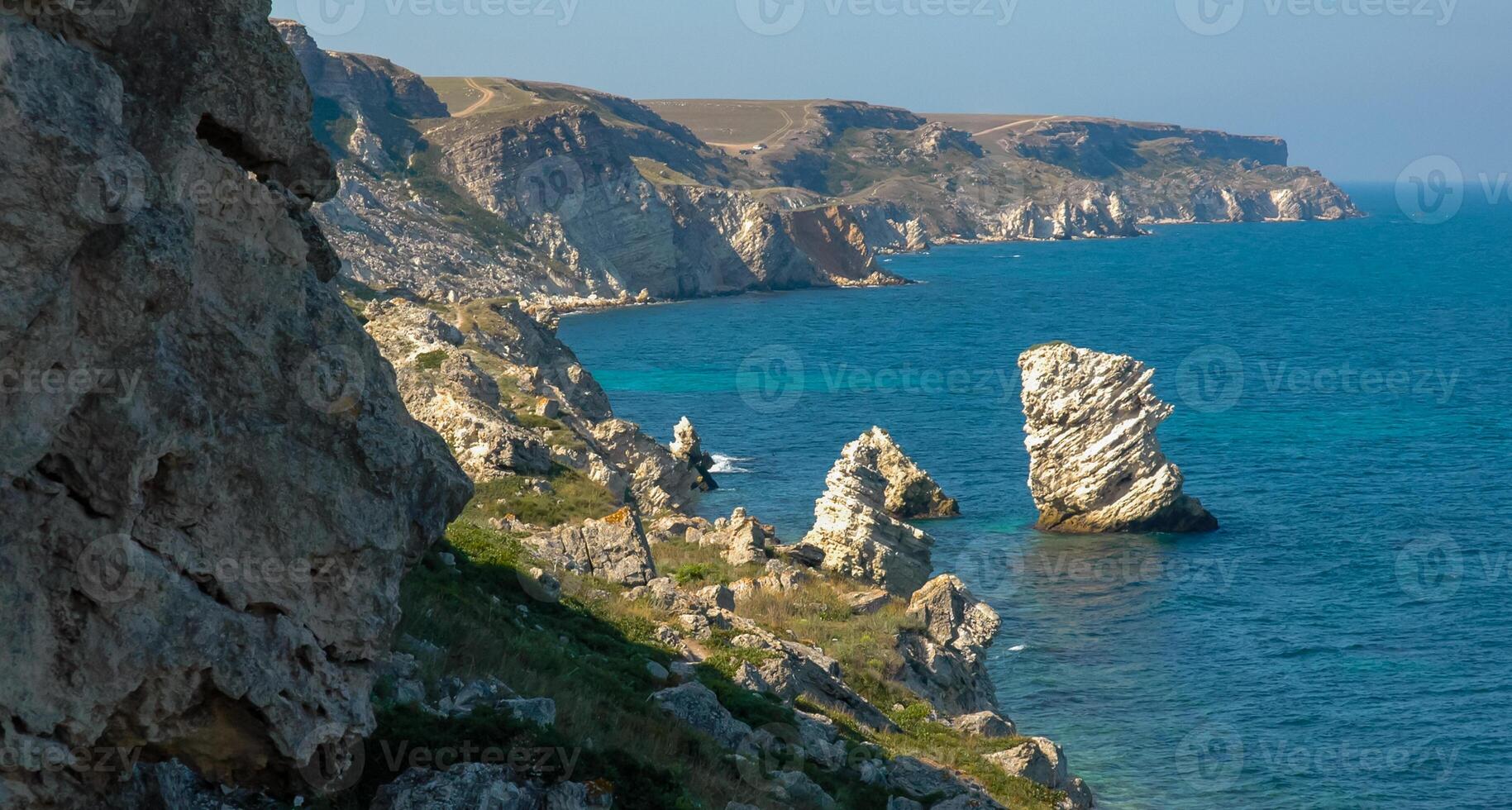 View of the steep banks and rocks in the water in the Dzhangul tract, western Crimea photo