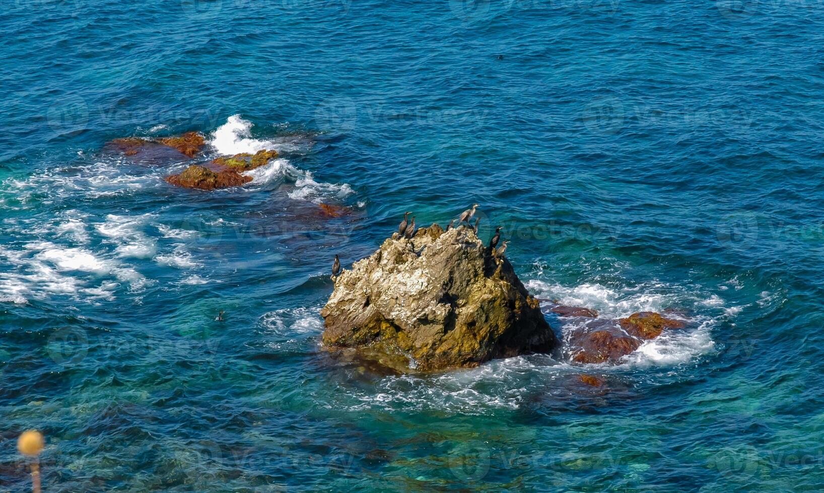 Rocks and islands in the water of the Black Sea near the landslide coast of Dzhangul in the western Crimea, Tarkhankut photo