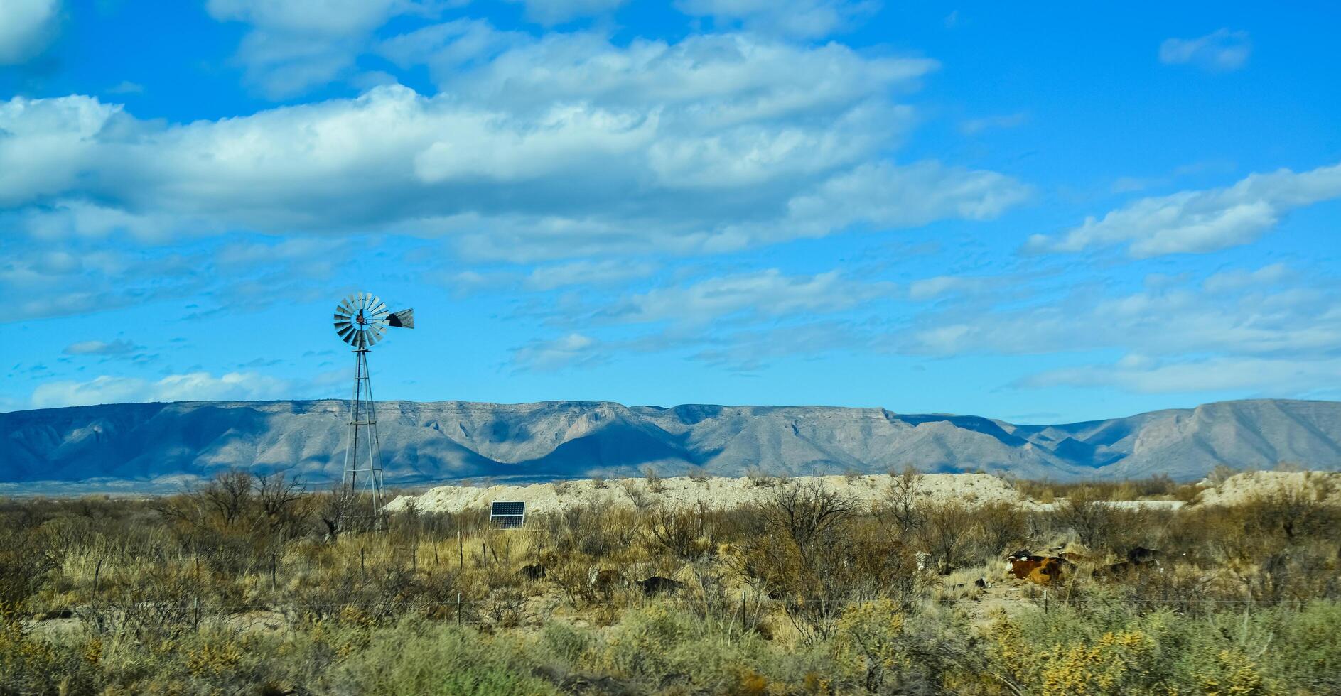 NEW MEXICO, USA - NOVEMBER 22, 2019 Small wind generator and solar panel in a Guadalupe mountain valley in New Mexico, USA photo